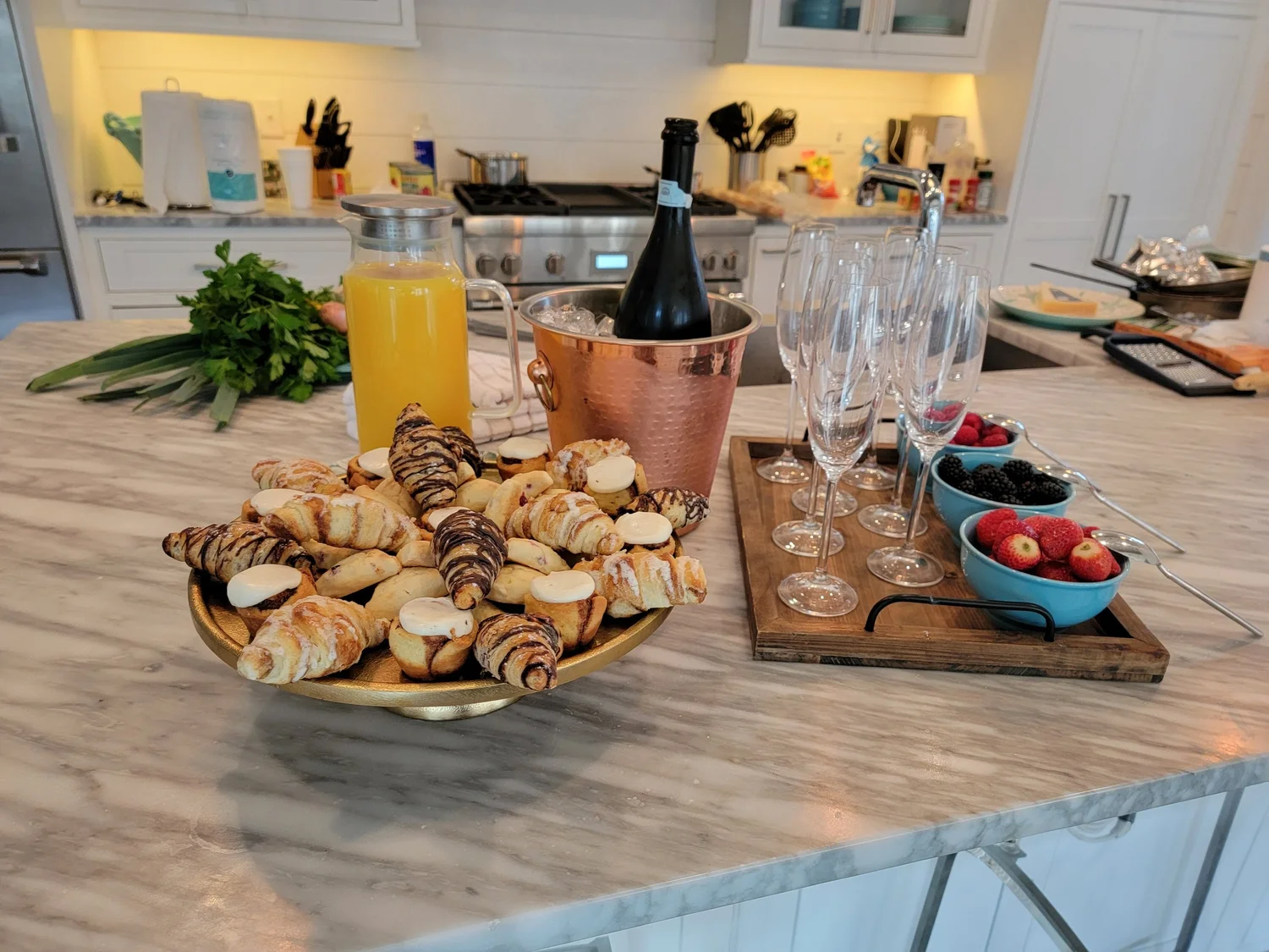 Croissants, orange juice and champagne laid out for a 30A rental brunch