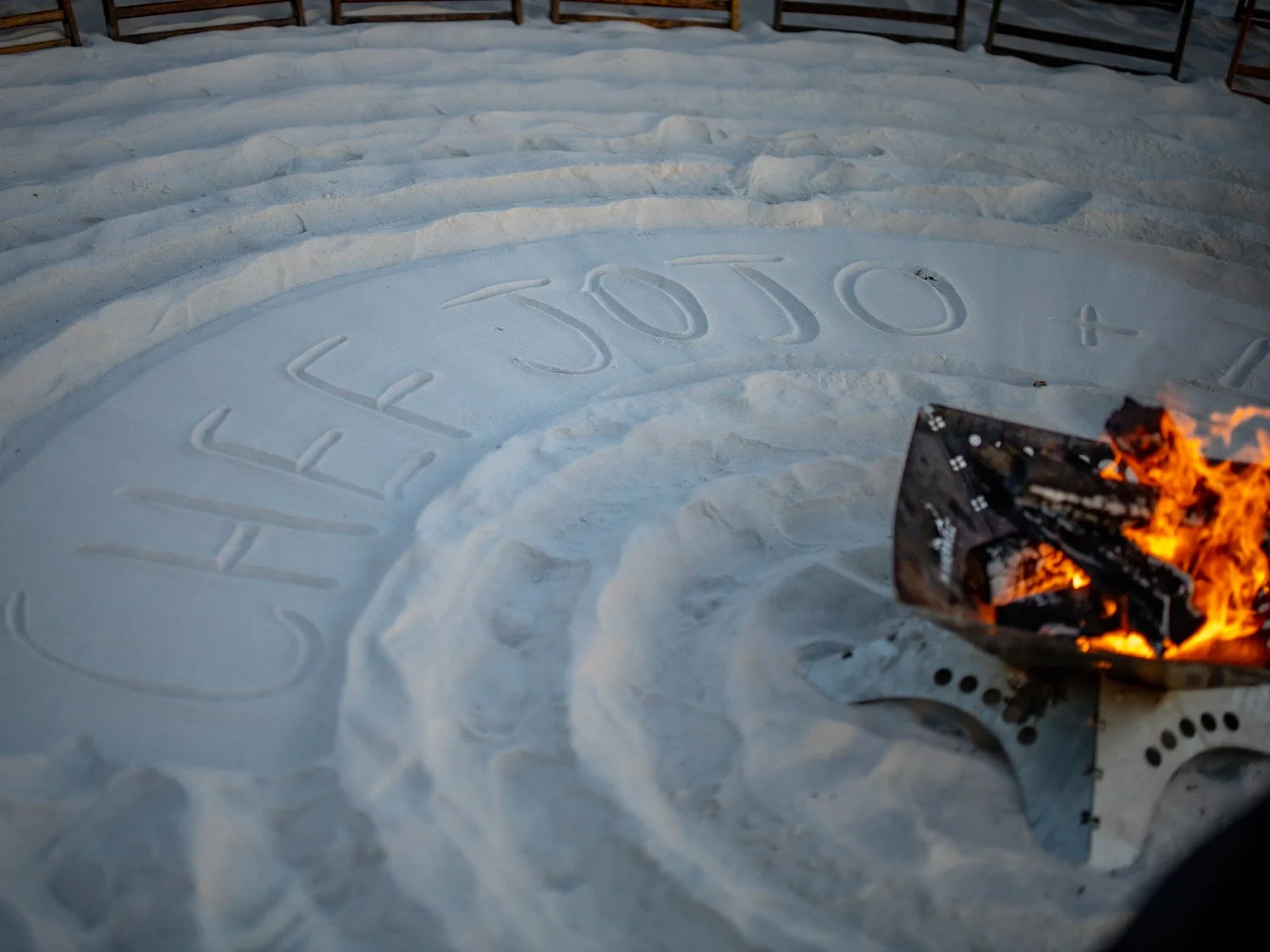 "Chef Jojo" written in the sand beside a beach bonfire on 30A