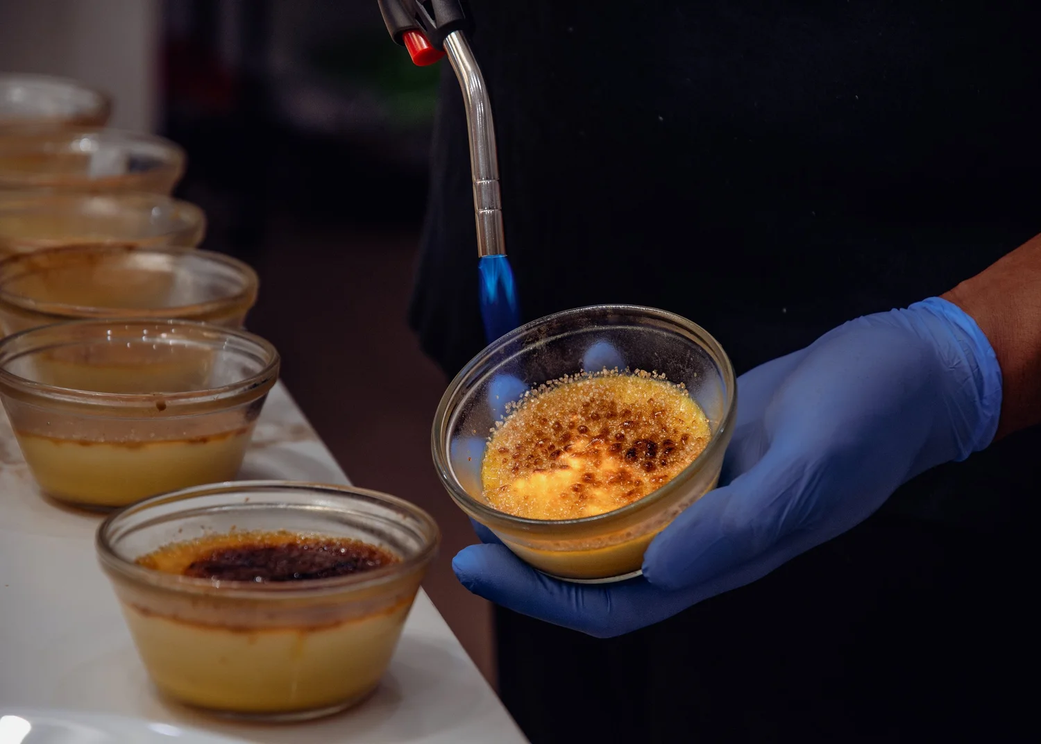 Chef torching crème brûlée to order at a private dinner