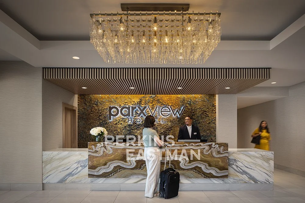 Parxview Hotel_Photo Int Arrival Reception Desk w People_Photograph by Andrew Rugge - Copyright Perkins Eastman.jpg