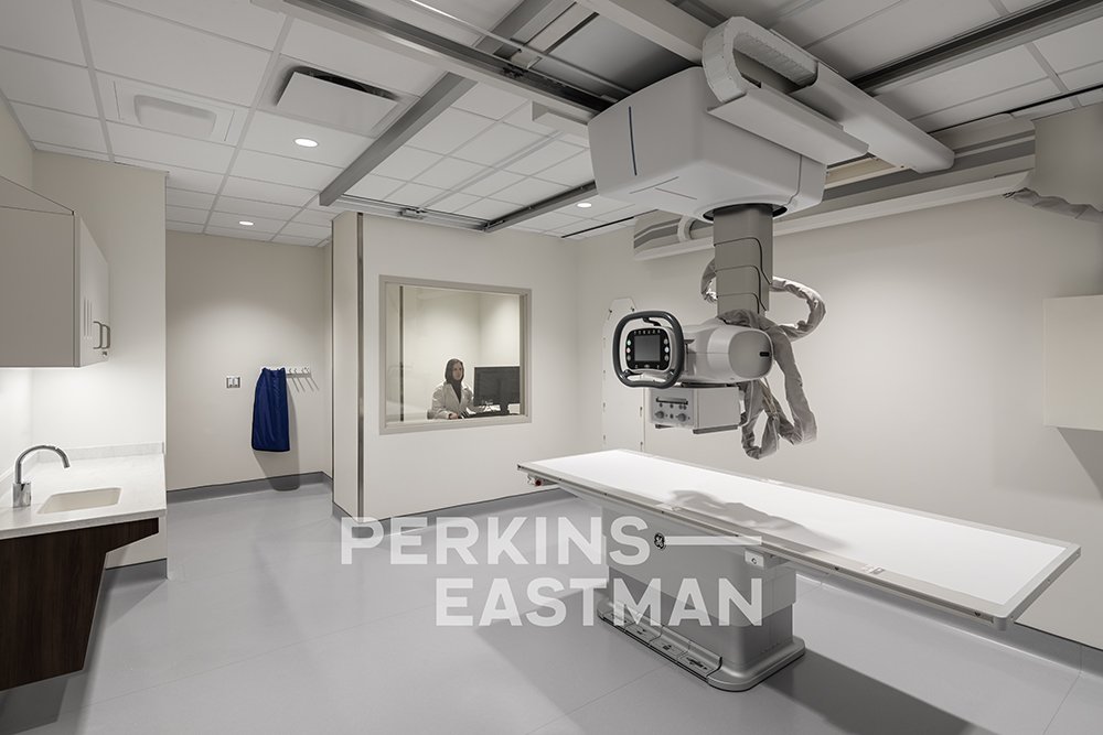 NYC H+H - Covid Centers - Bronx_Photo Int Procedure Room X-Ray w People_Photograph by Andrew Rugge - Copyright Perkins Eastman.jpg