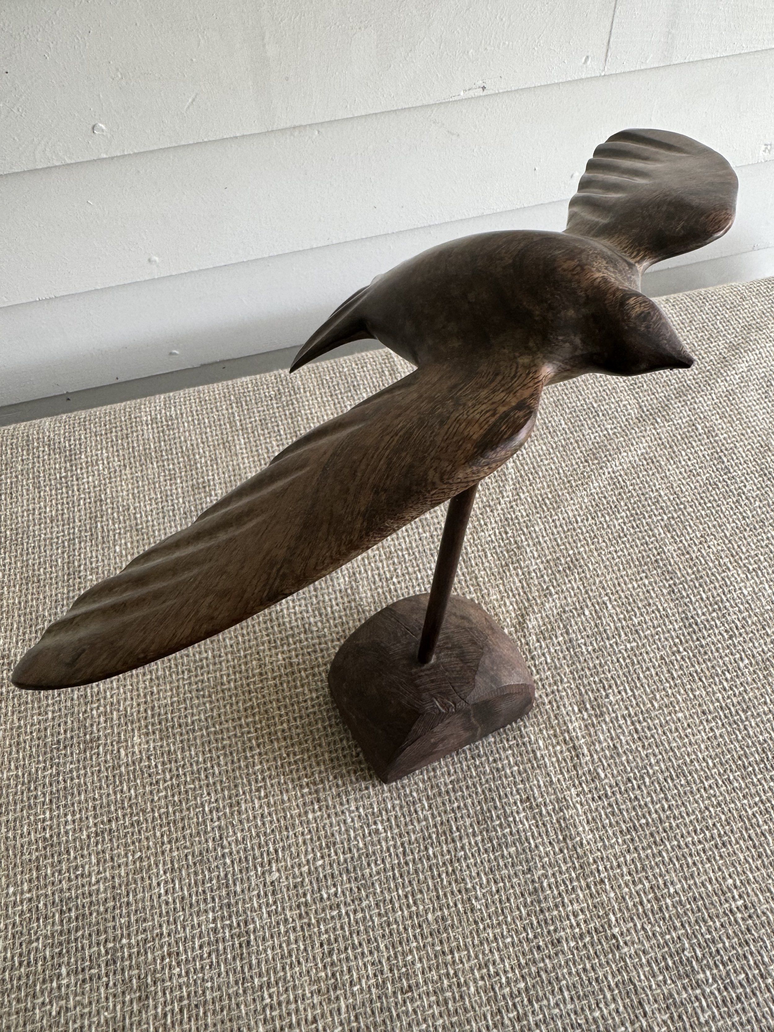 Carved wood bird in flight