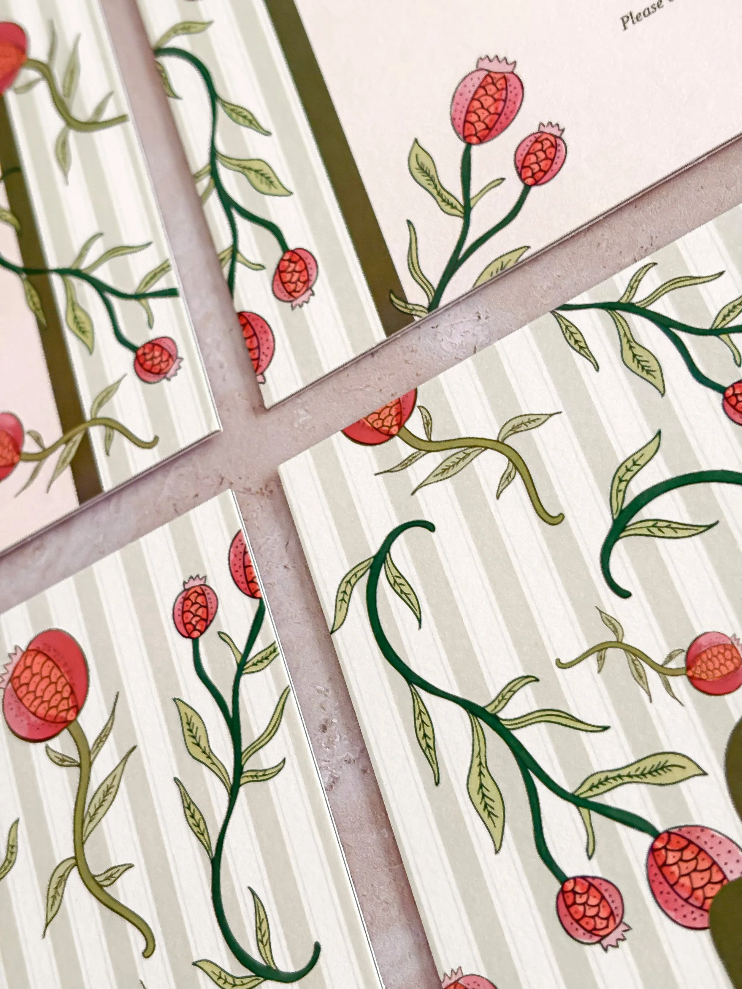 Close-up illustrative details of colourful wedding reception food station signs with bespoke pomegranate botanical pattern.