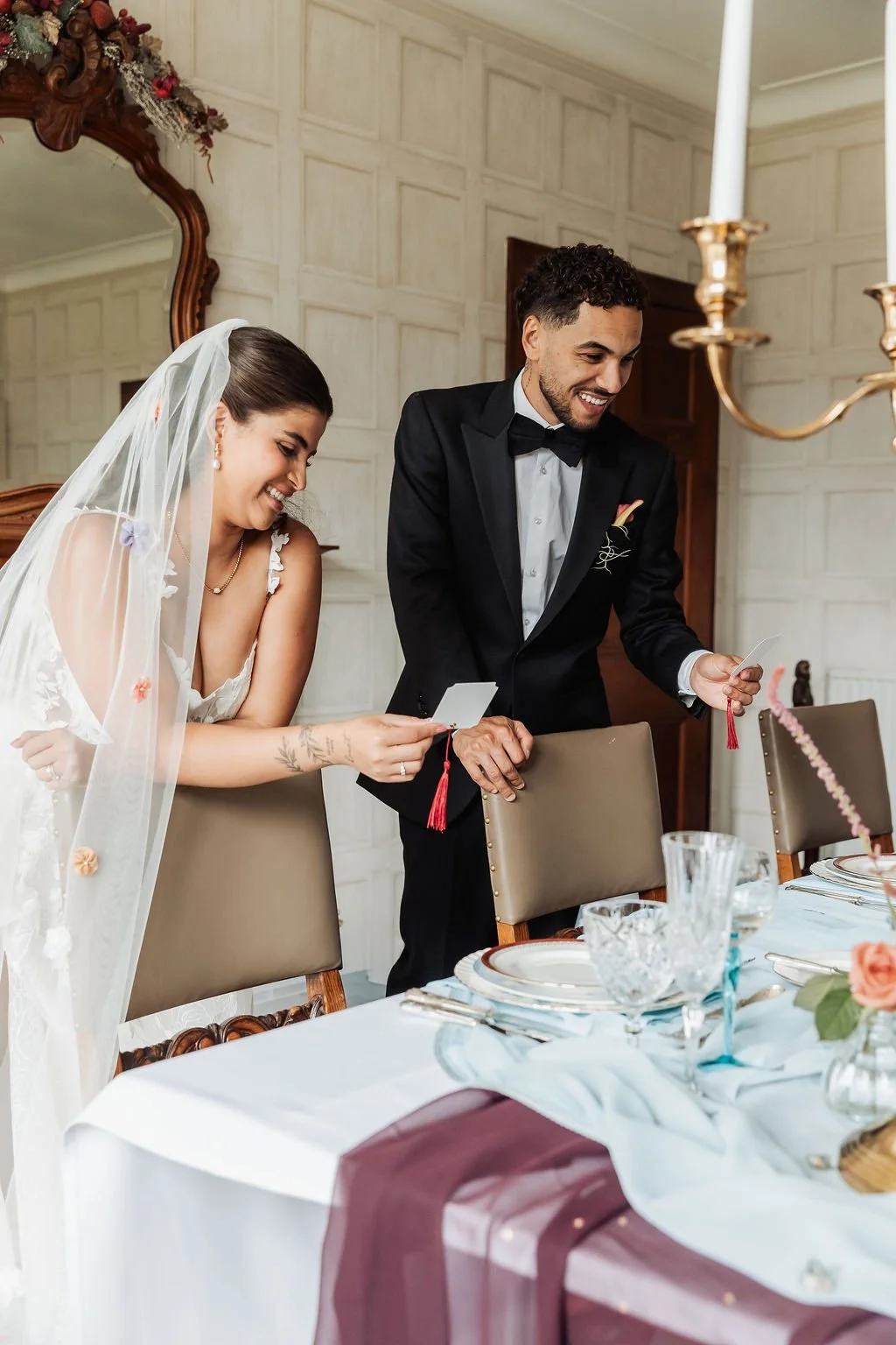 Luxury wedding place cards in ivory and powder blue, adorned with burgundy tassels. Stationery designed by Carrie at Honey Bee Mine, and captured in the Scottish Highlands.