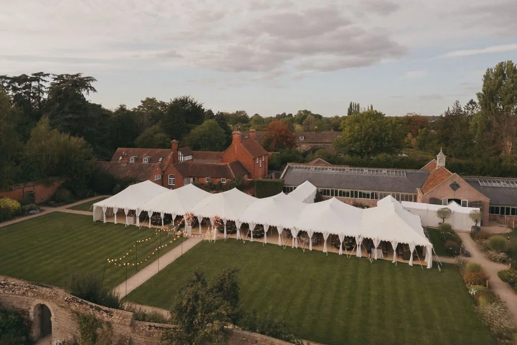 A large outdoor white event marquee set up on the lawn at Kin House for a multi-day wedding celebration. 