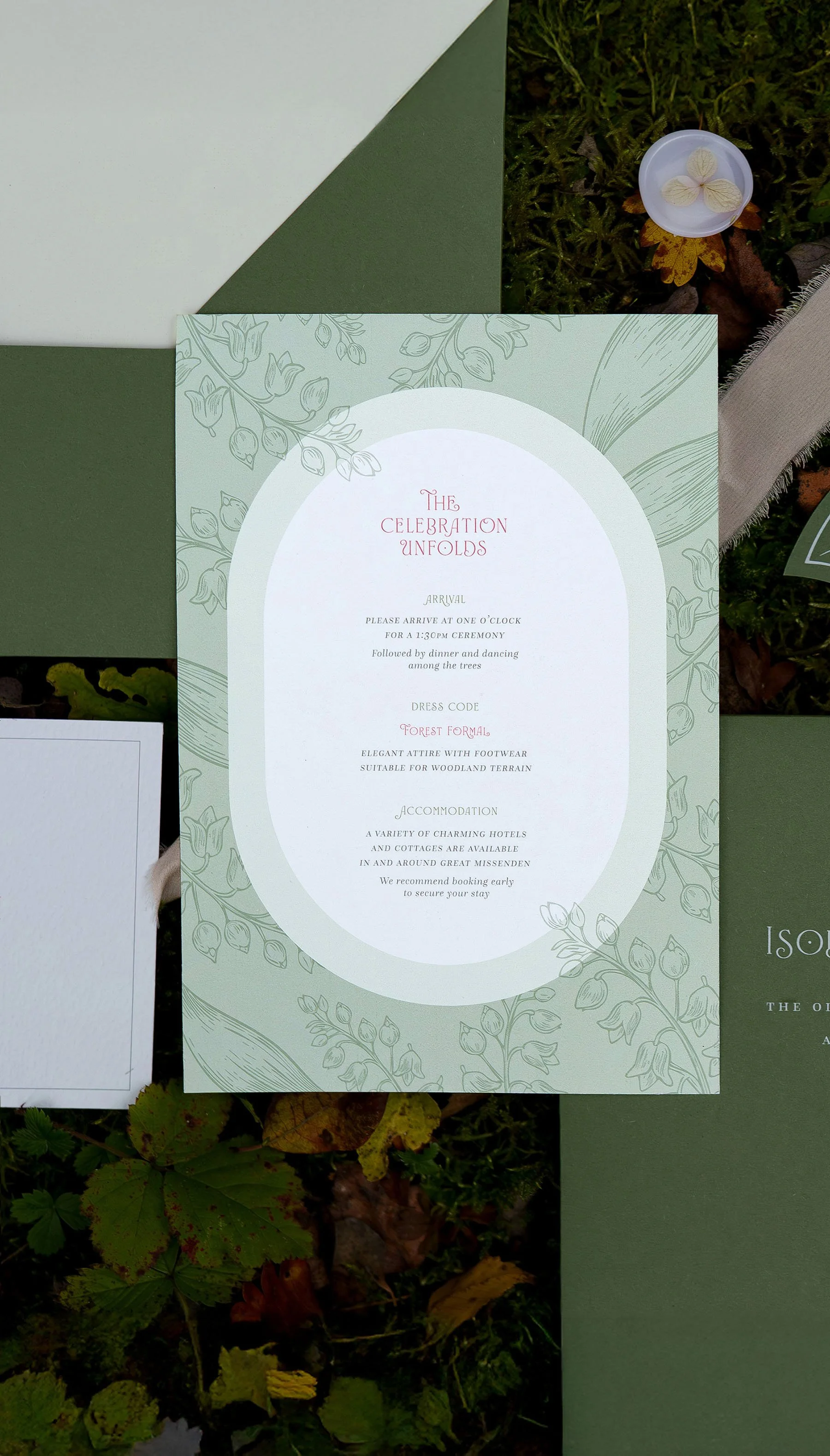 Organic luxury wedding invitation with botanical detail and die-cut shapes photographed among woodland foliage at Sylvan Ferns.