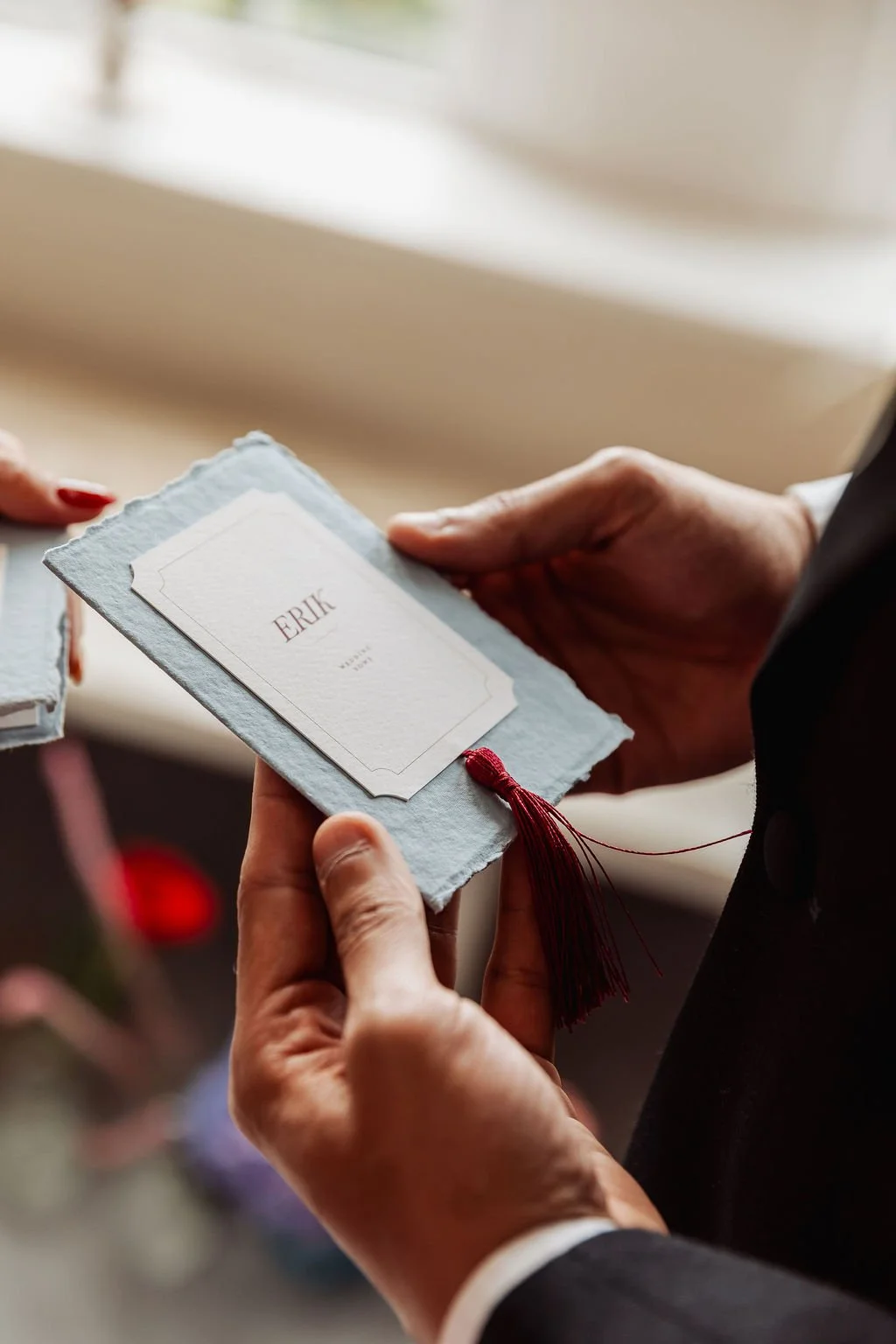 Luxury wedding vow books in powder blue, ivory and burgundy tones, made with handmade deckled paper and finished with burgundy tassels. Designed by Carrie at Honey Bee Mine, and captured in the Scottish Highlands.