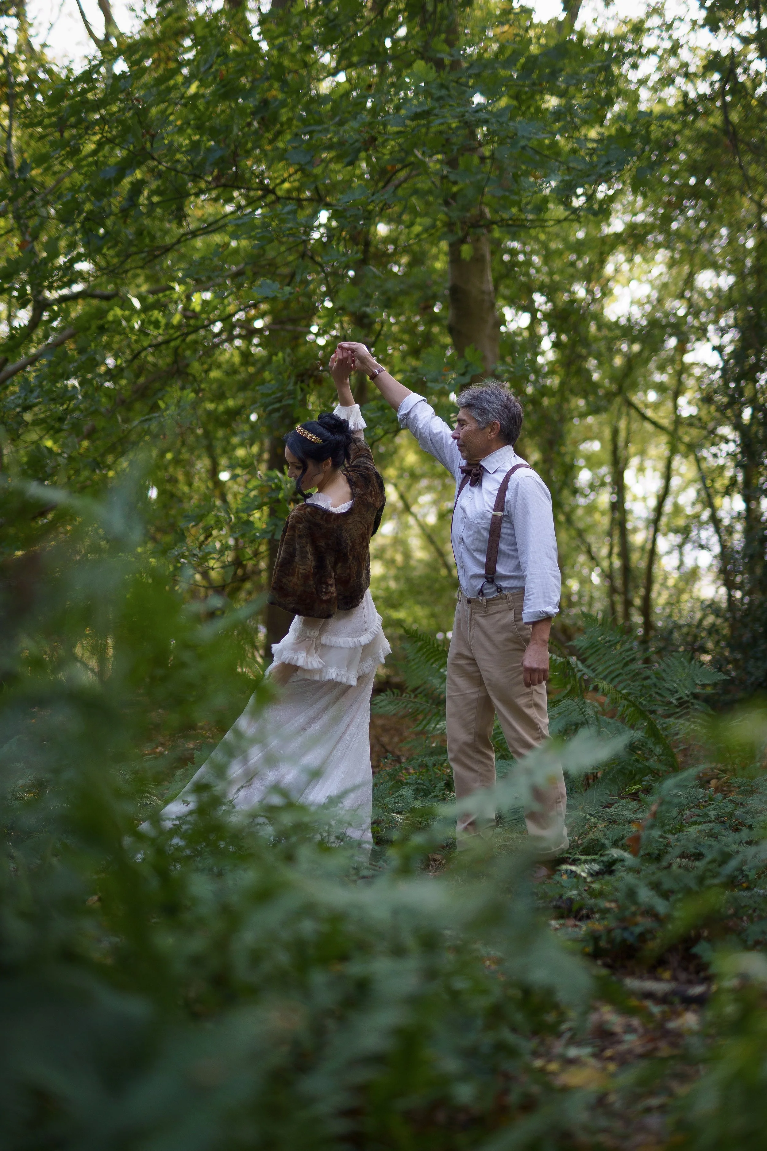 Bride and groom walking through woodland at Sylvan Ferns during an intimate wedding editorial.