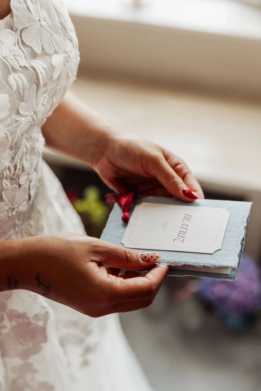 Luxury wedding vow books in powder blue, ivory and burgundy tones, made with handmade deckled paper and finished with burgundy tassels. Designed by Carrie at Honey Bee Mine, and captured in the Scottish Highlands.