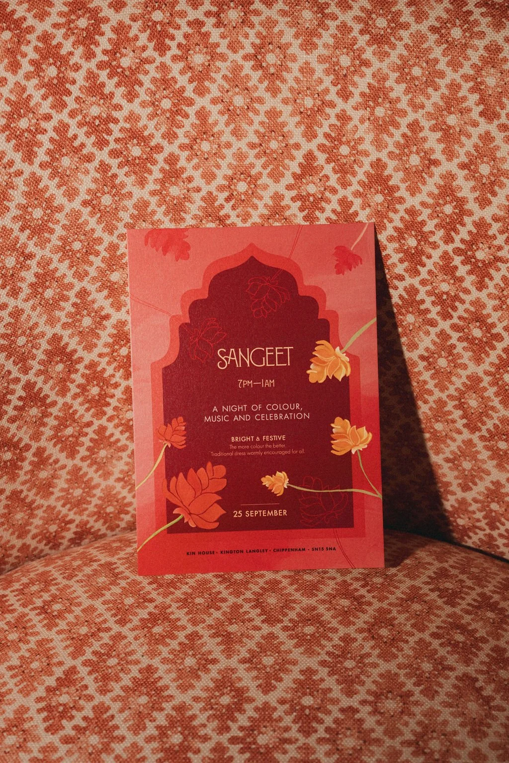 Fuchsia Sangeet wedding stationery with colourful botanical illustration.