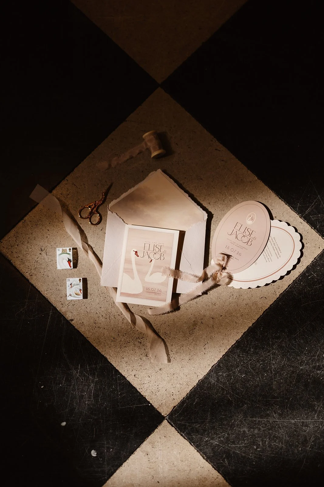 Luxury wedding invitation suite with hand illustrated swans, soft blush tones, scalloped edges and pure silk ribbon. Designed by Carrie at Honey Bee Mine, and captured at Capesthorne Hall.