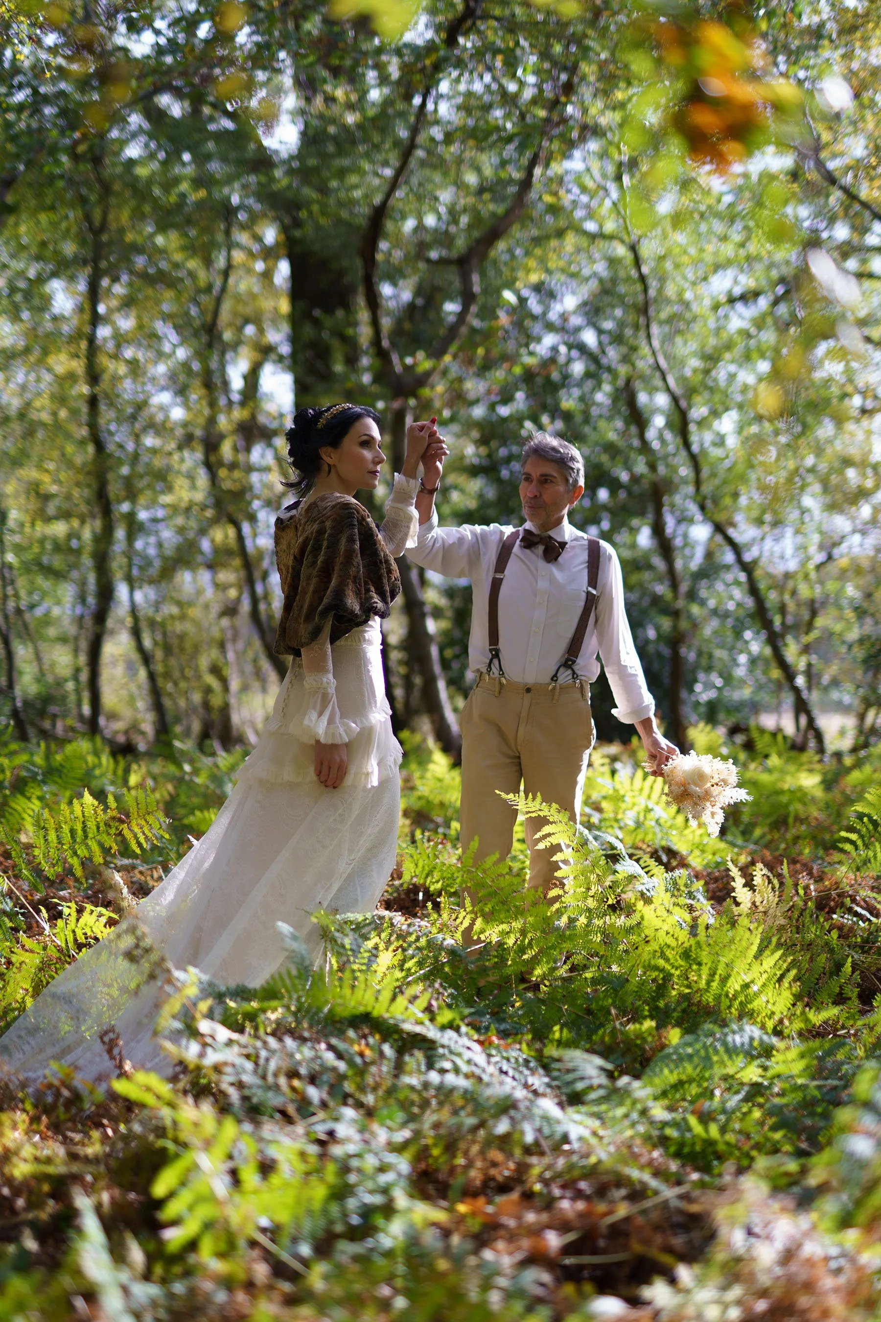 Bride and groom walking through woodland at Sylvan Ferns during an intimate wedding editorial.