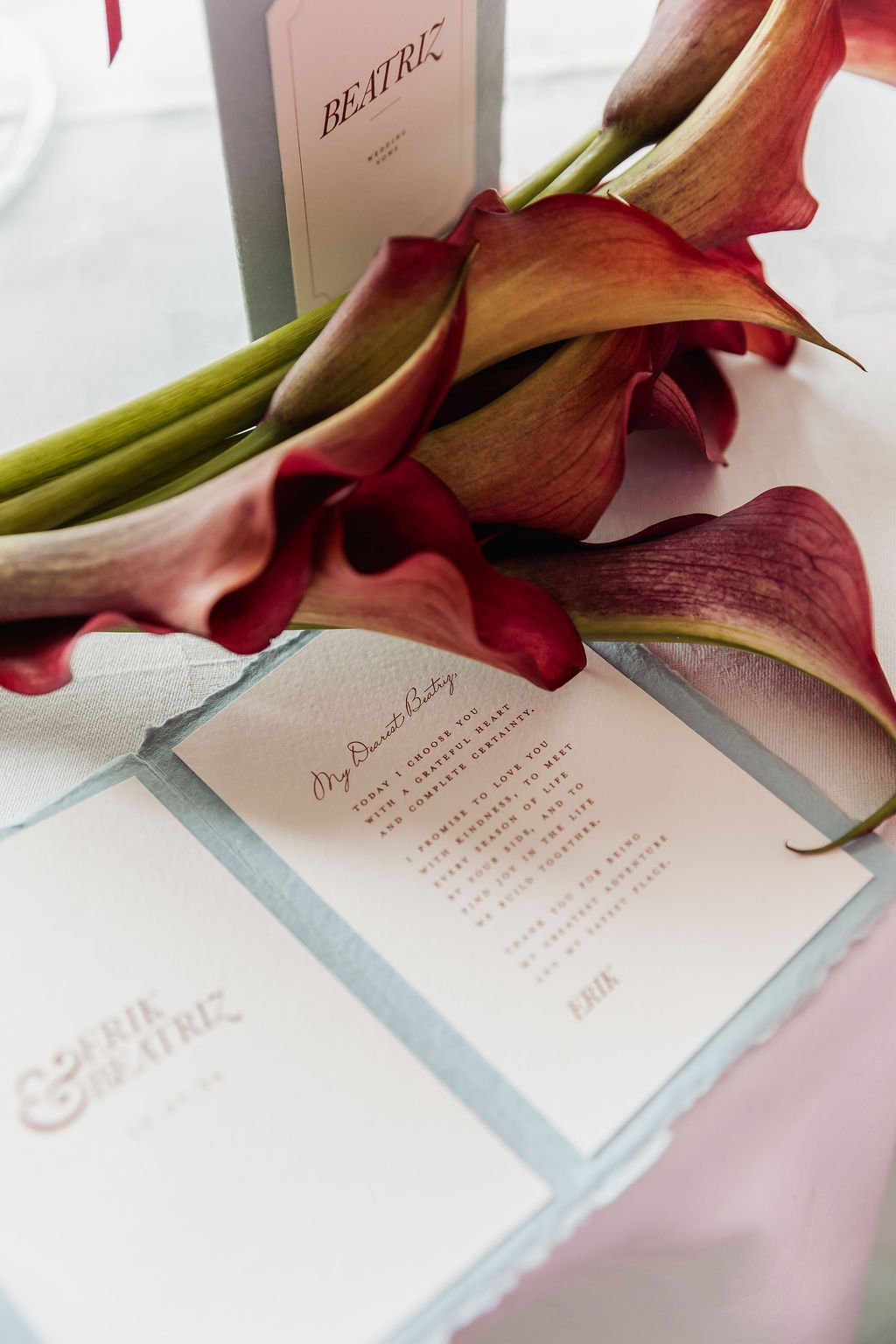 Luxury wedding vow books in powder blue, ivory and burgundy tones, made with handmade deckled paper and finished with burgundy tassels. Designed by Carrie at Honey Bee Mine, and captured in the Scottish Highlands.
