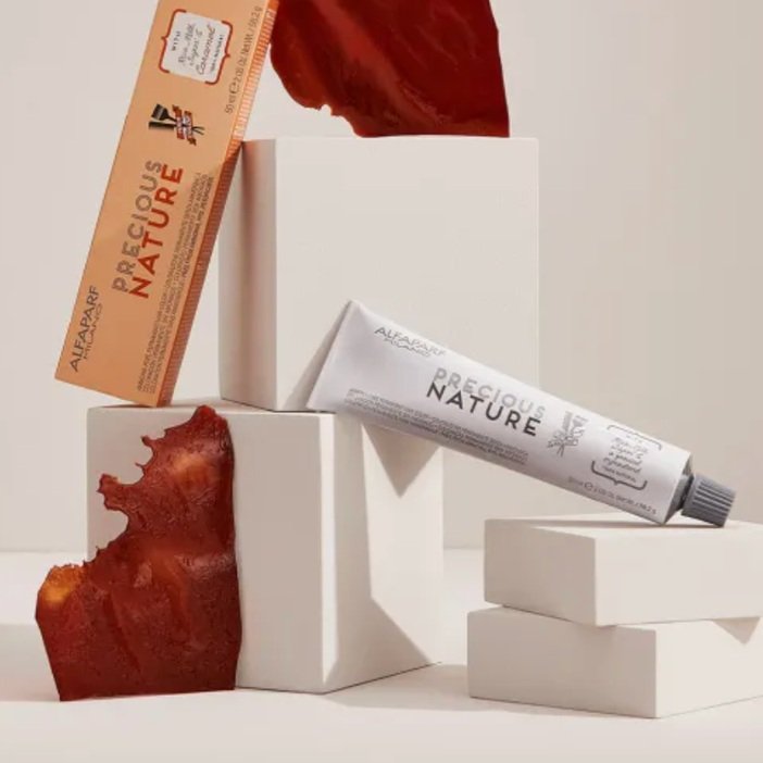 Skincare products and two pieces of bark on white blocks and a white background.