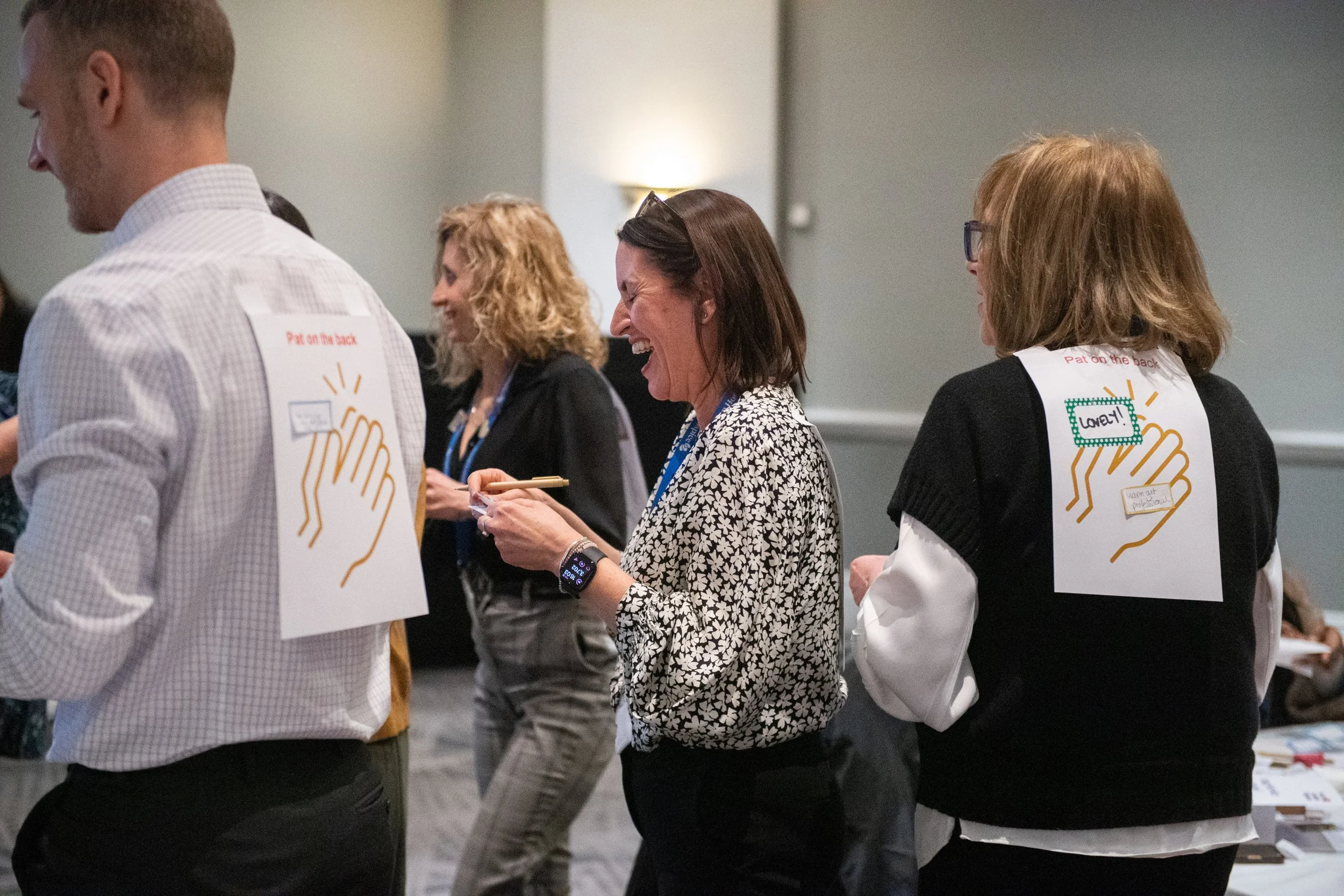 Conference attendees laugh during team bonding session