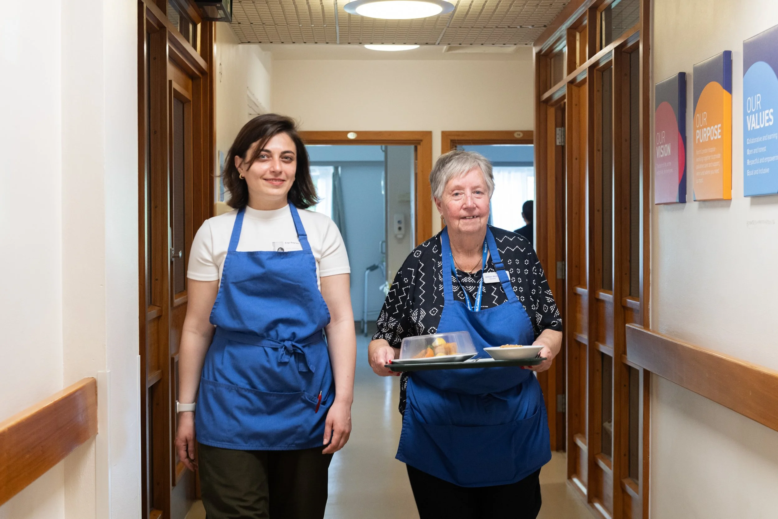 Volunteers in IPU corridor delivering lunch to patients