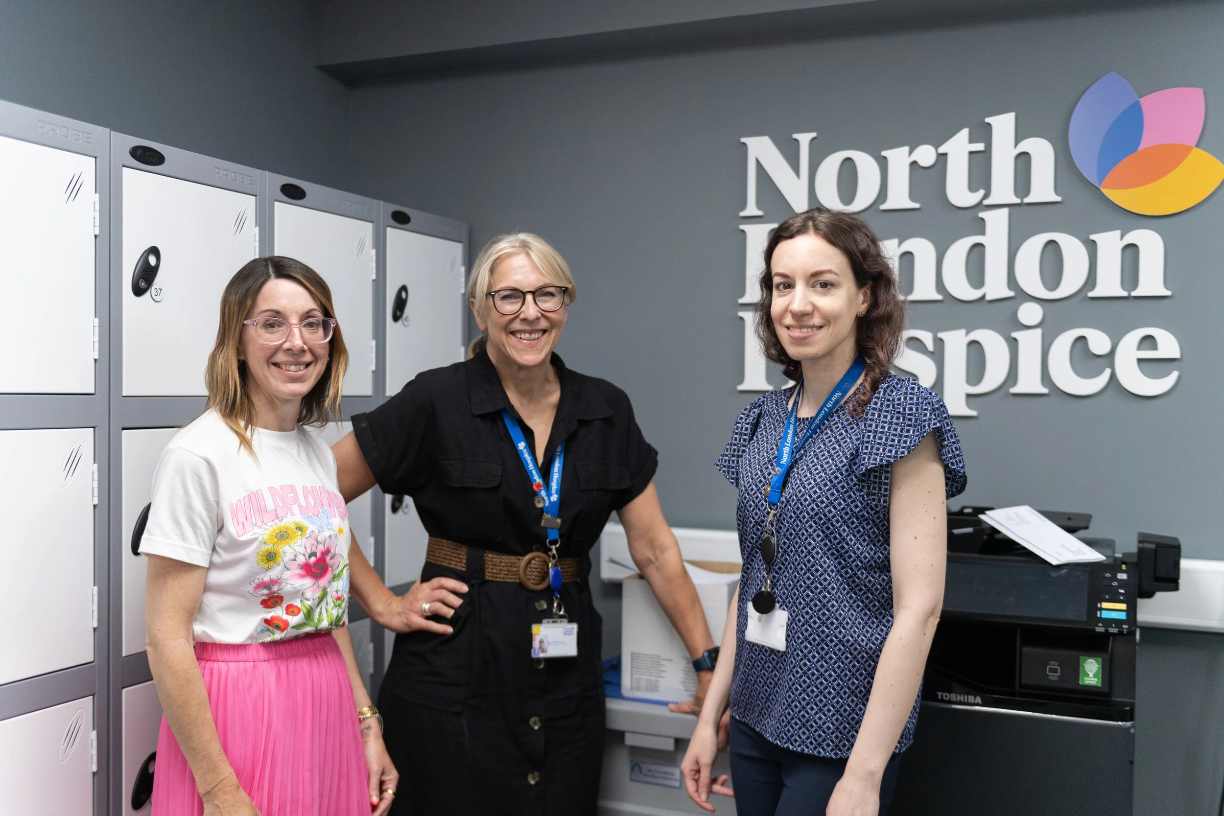 Accounts department team pose in communal office space 