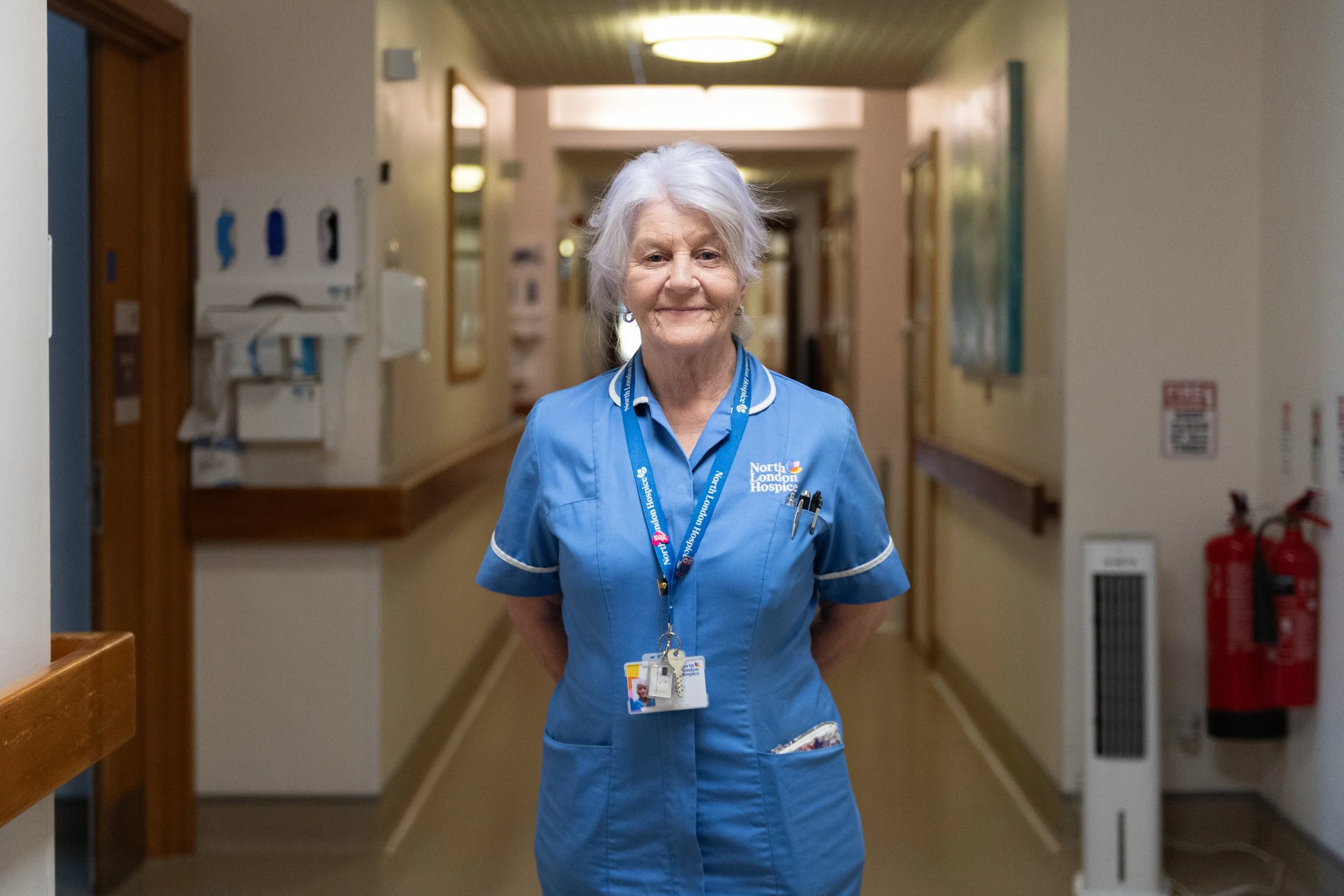 North London Hospice carer posing in IPU corridor