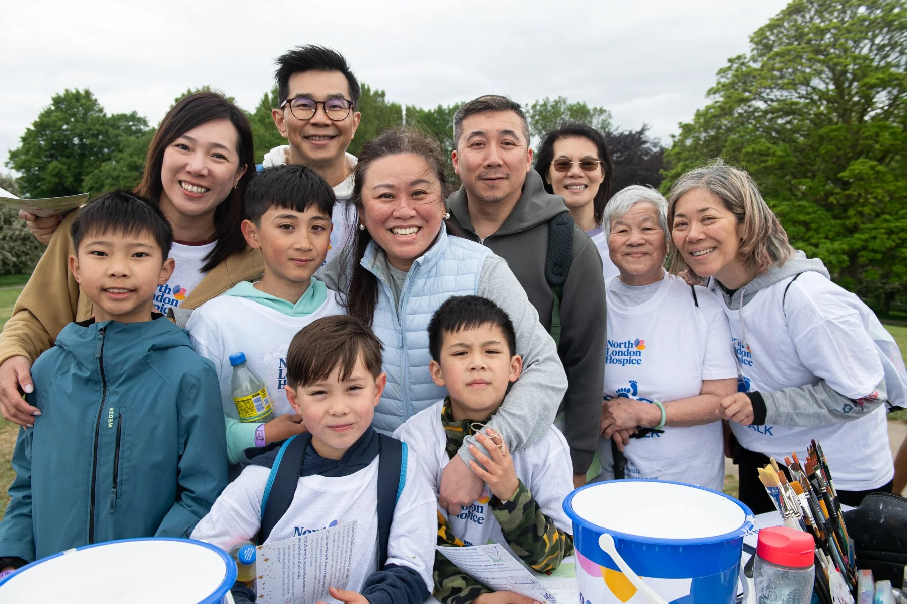 Portrait Photography. A happy Asian Family of eleven (11) smiling and posing for a photo after completing the North London Hospice Big Fun Walk