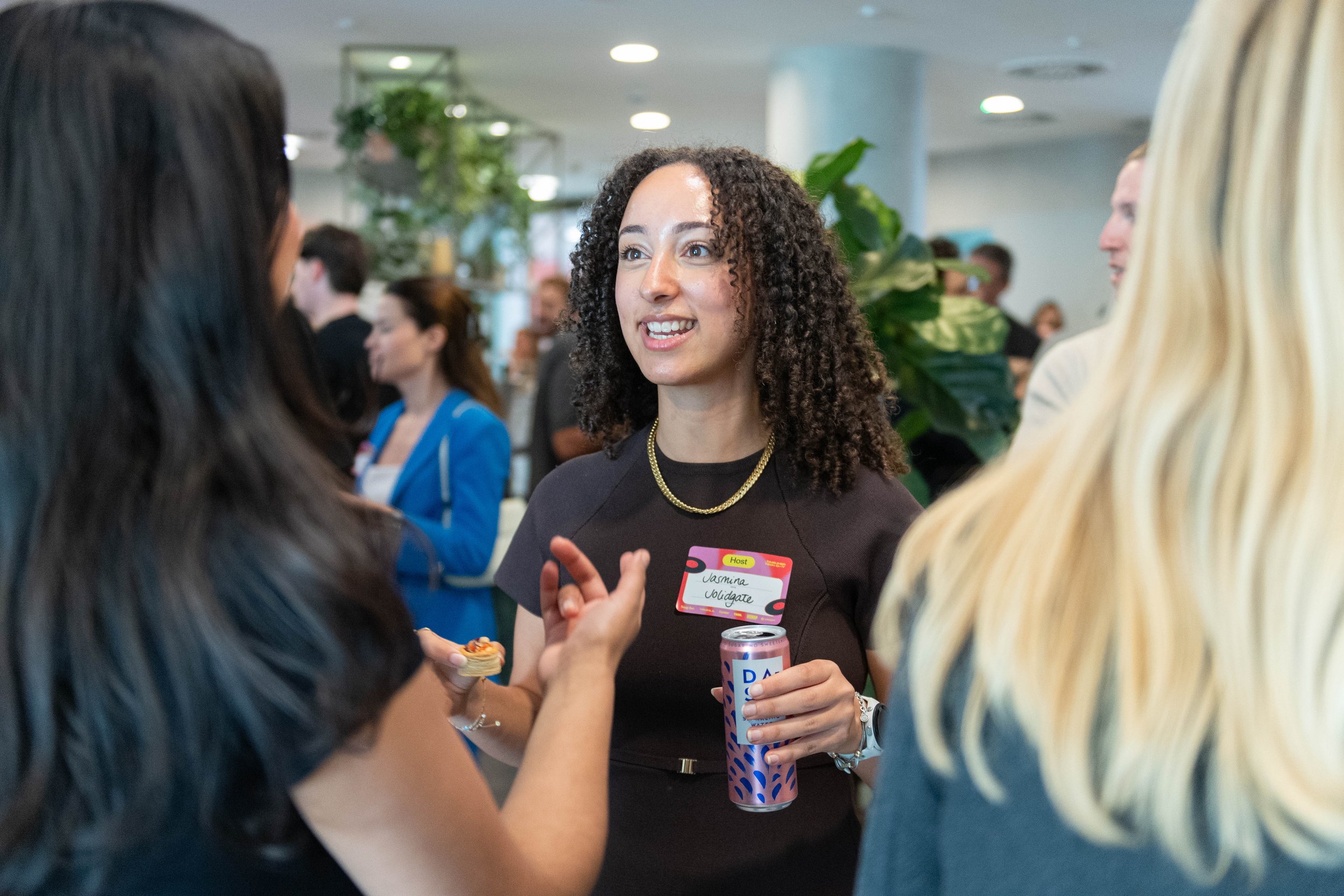 A woman with curly hair networking 
