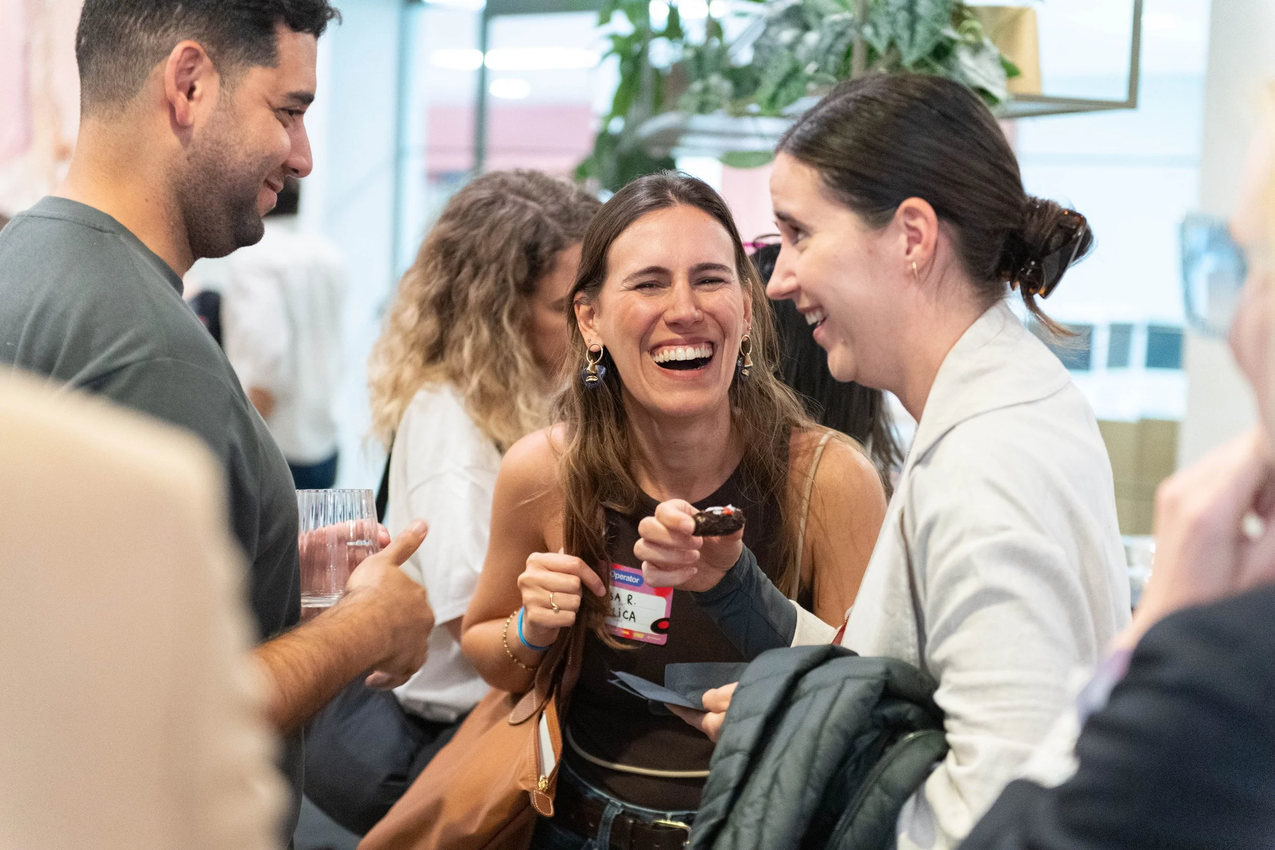 A networking evening attendee smiling and laughing with other guests