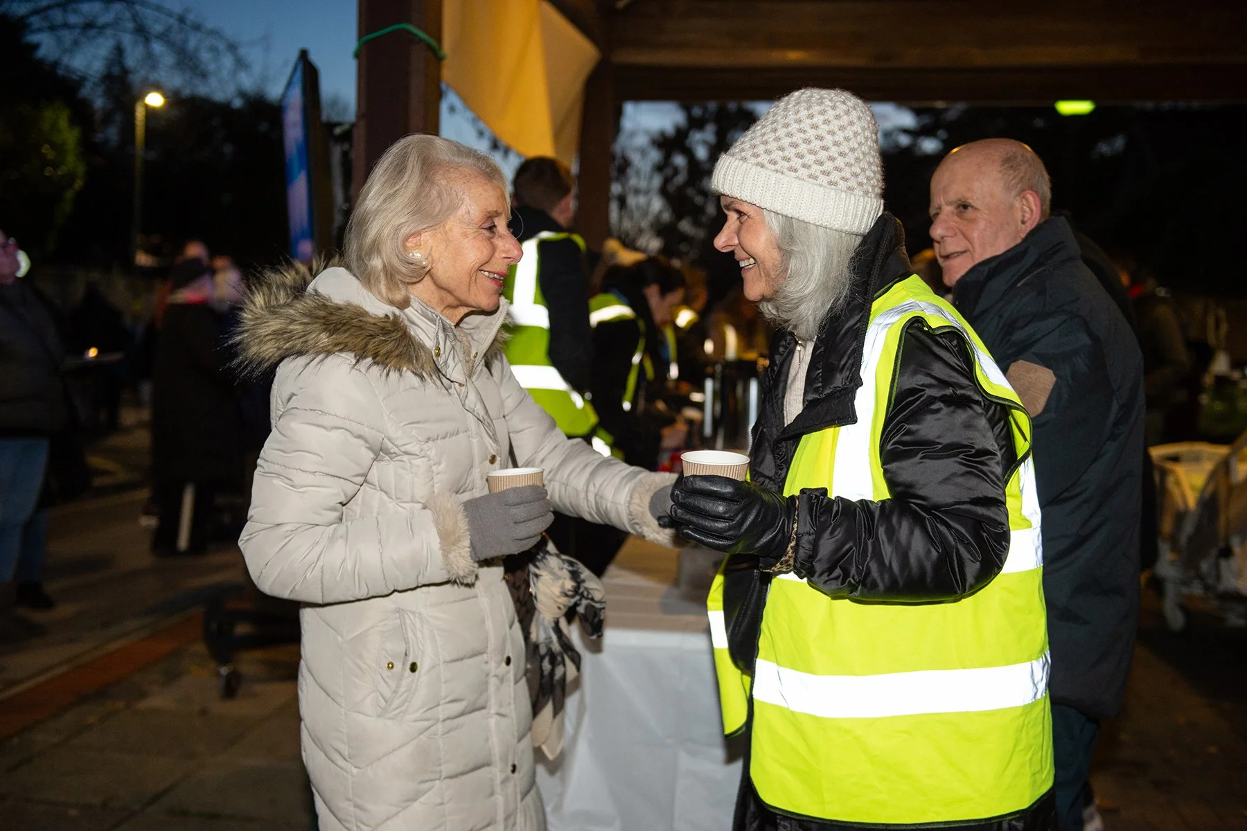 Volunteer and guest smiling and talking 