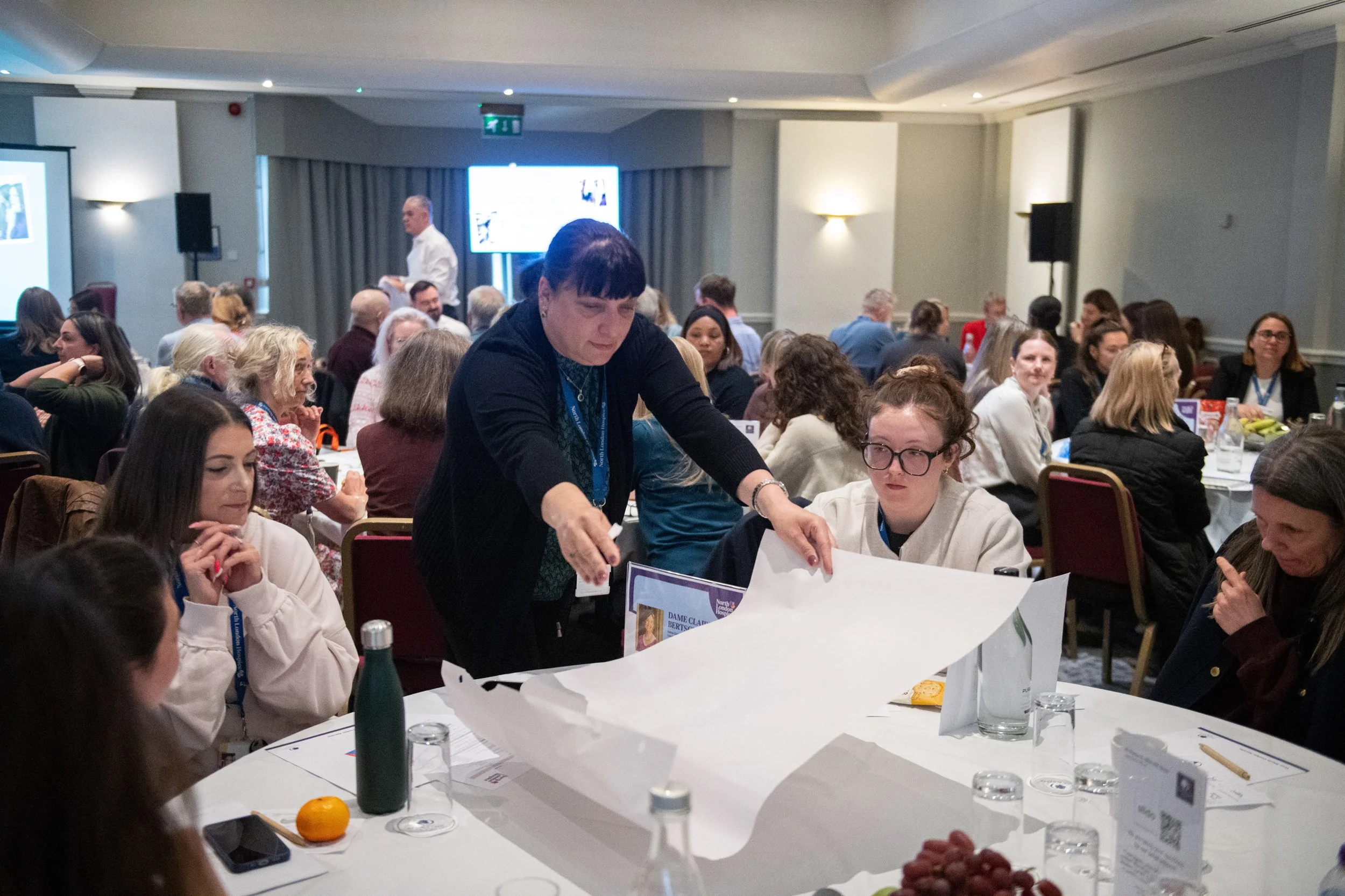 Attendees are given large sheets of paper for their first group session