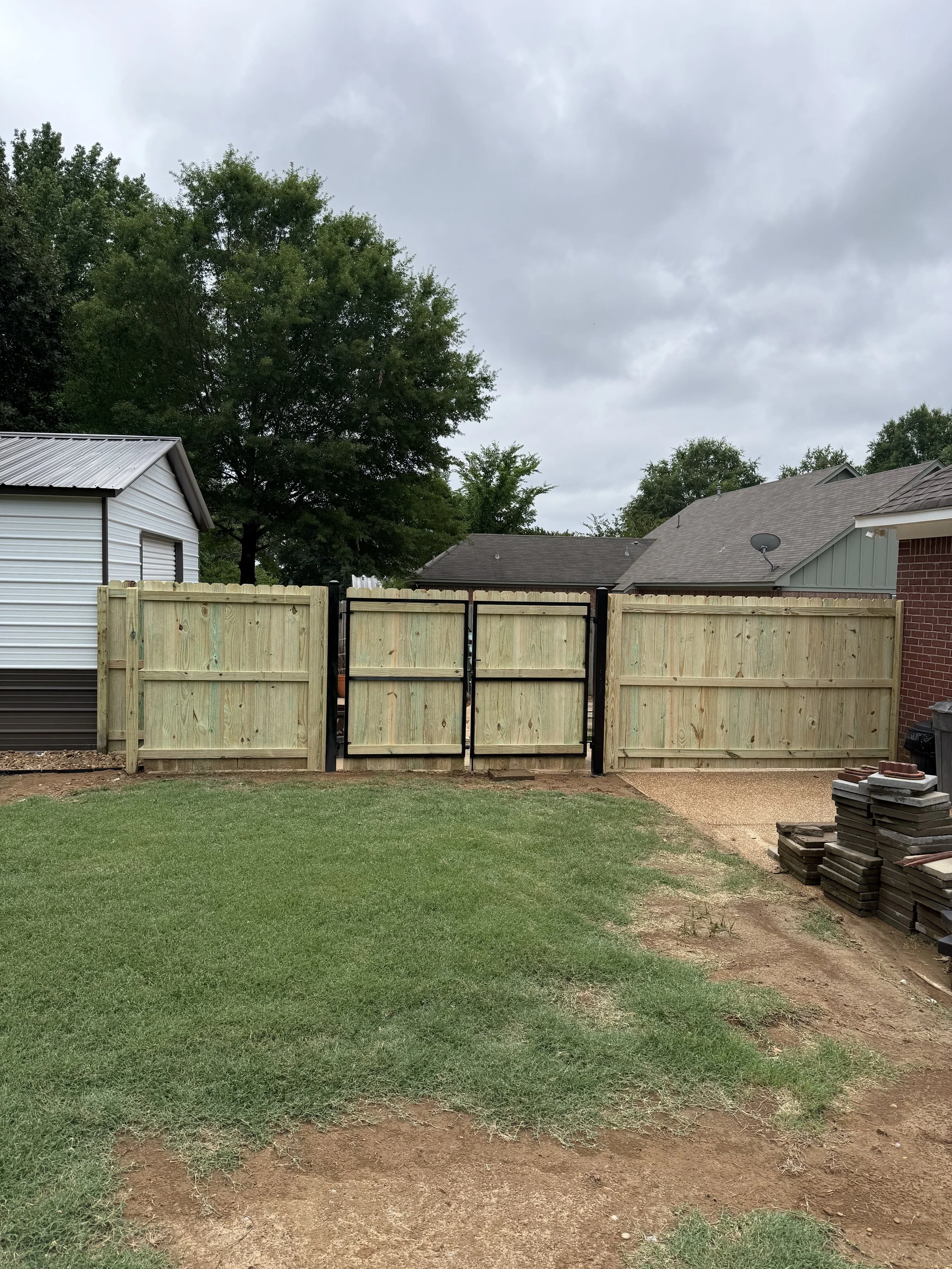 Pressure treated pine privacy fence with custom double steel frame gates installed in Hernando, MS by DeSoto Fence Co.