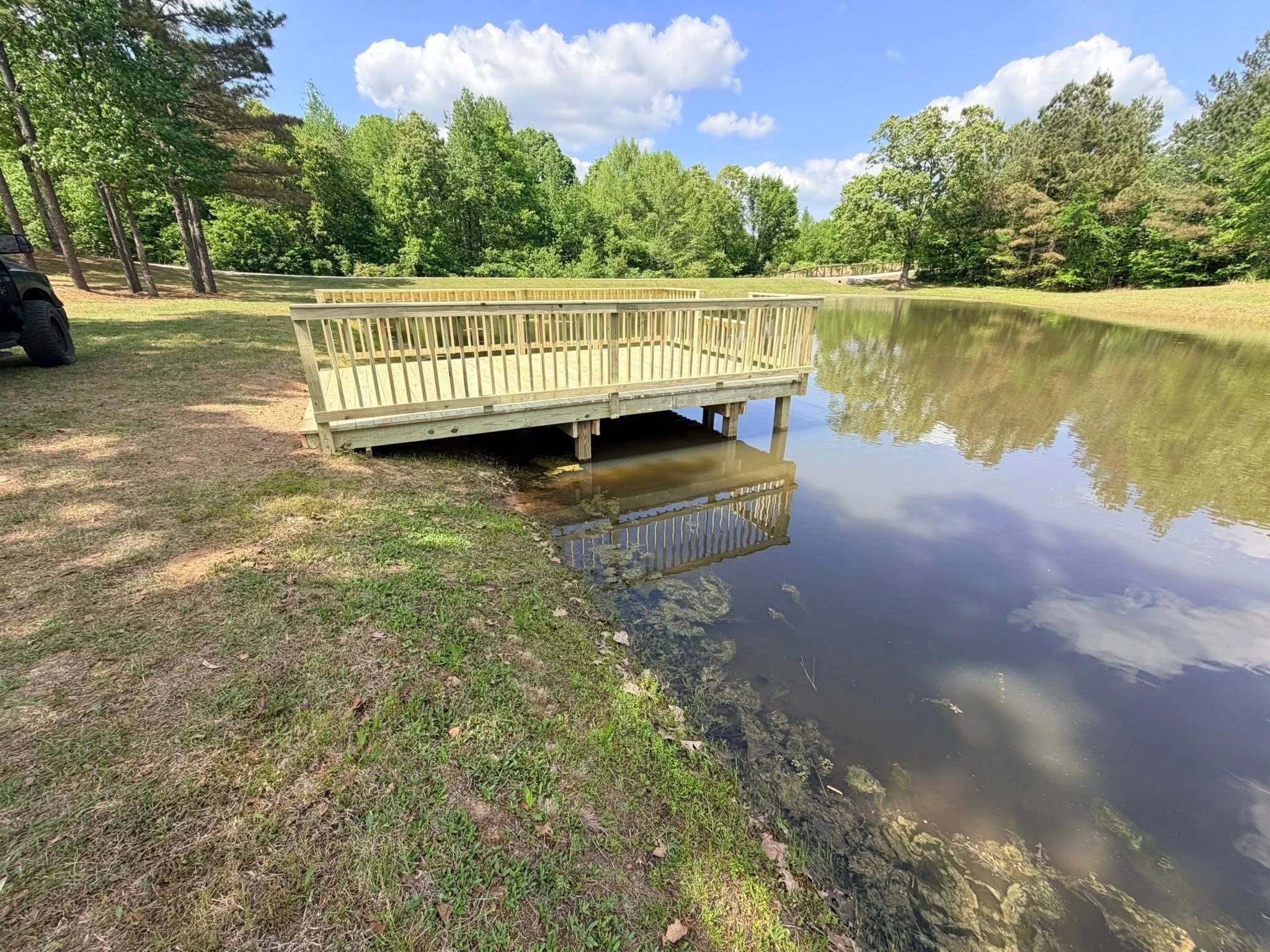 Wood Floating Dock in Hernando, Mississippi by DeSoto Fence Co. featuring pressure treated lumber, custom railings, spacious waterfront platform, and durable construction designed for recreation and long term performance.