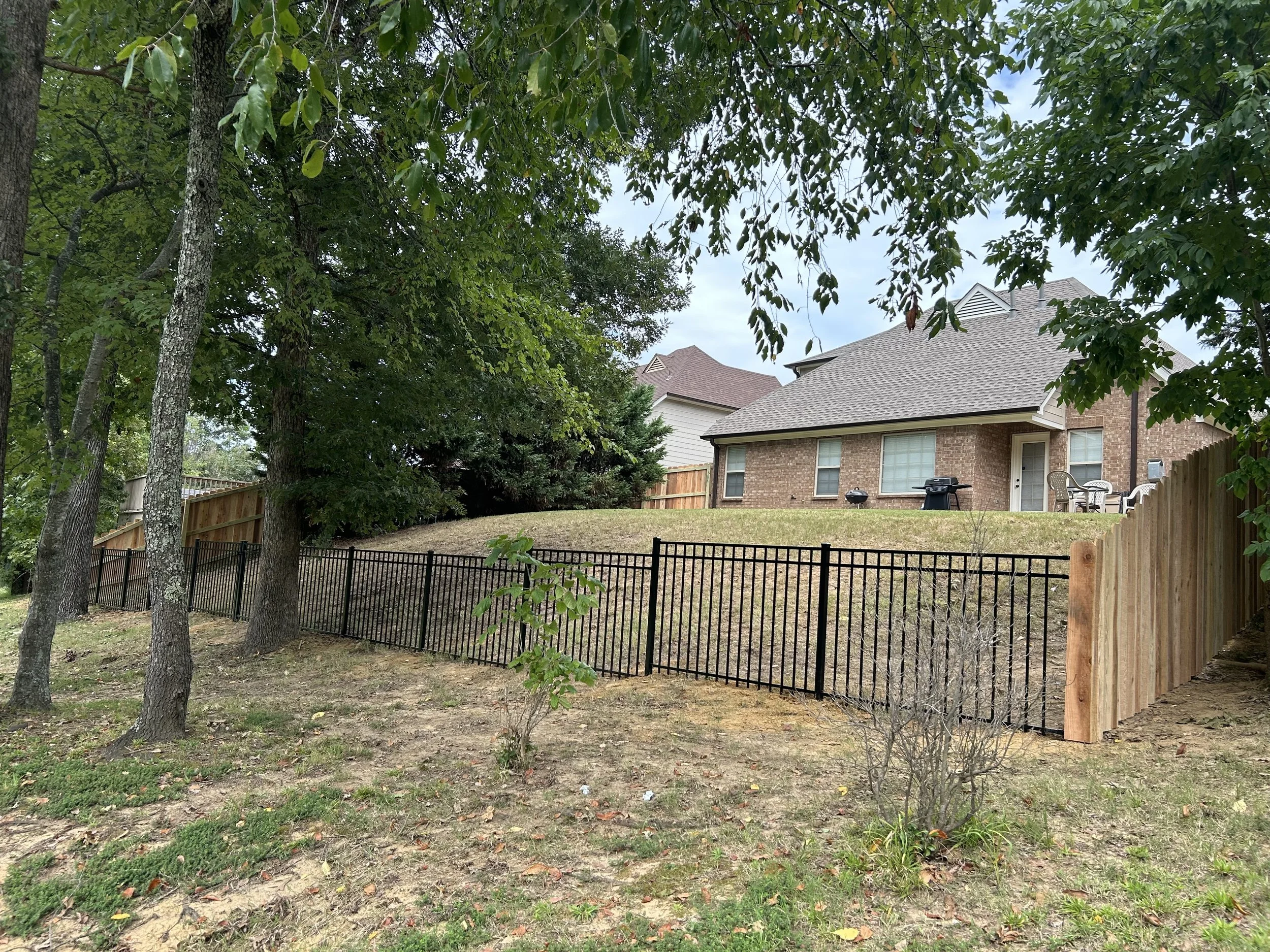 Black aluminum fence installation in Hernando, MS providing security while preserving scenic golf course views and curb appeal.