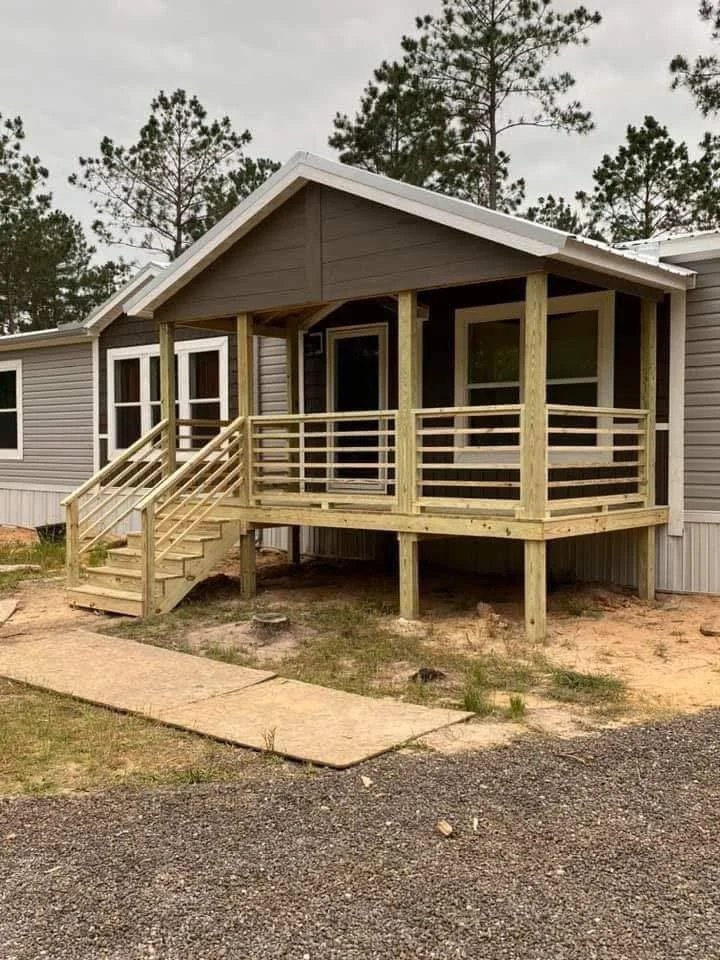 Pressure Treated Wood Deck in Olive Branch, Mississippi by DeSoto Fence Co. featuring covered outdoor living space, custom stairs, and durable construction designed for long lasting enjoyment and curb appeal.