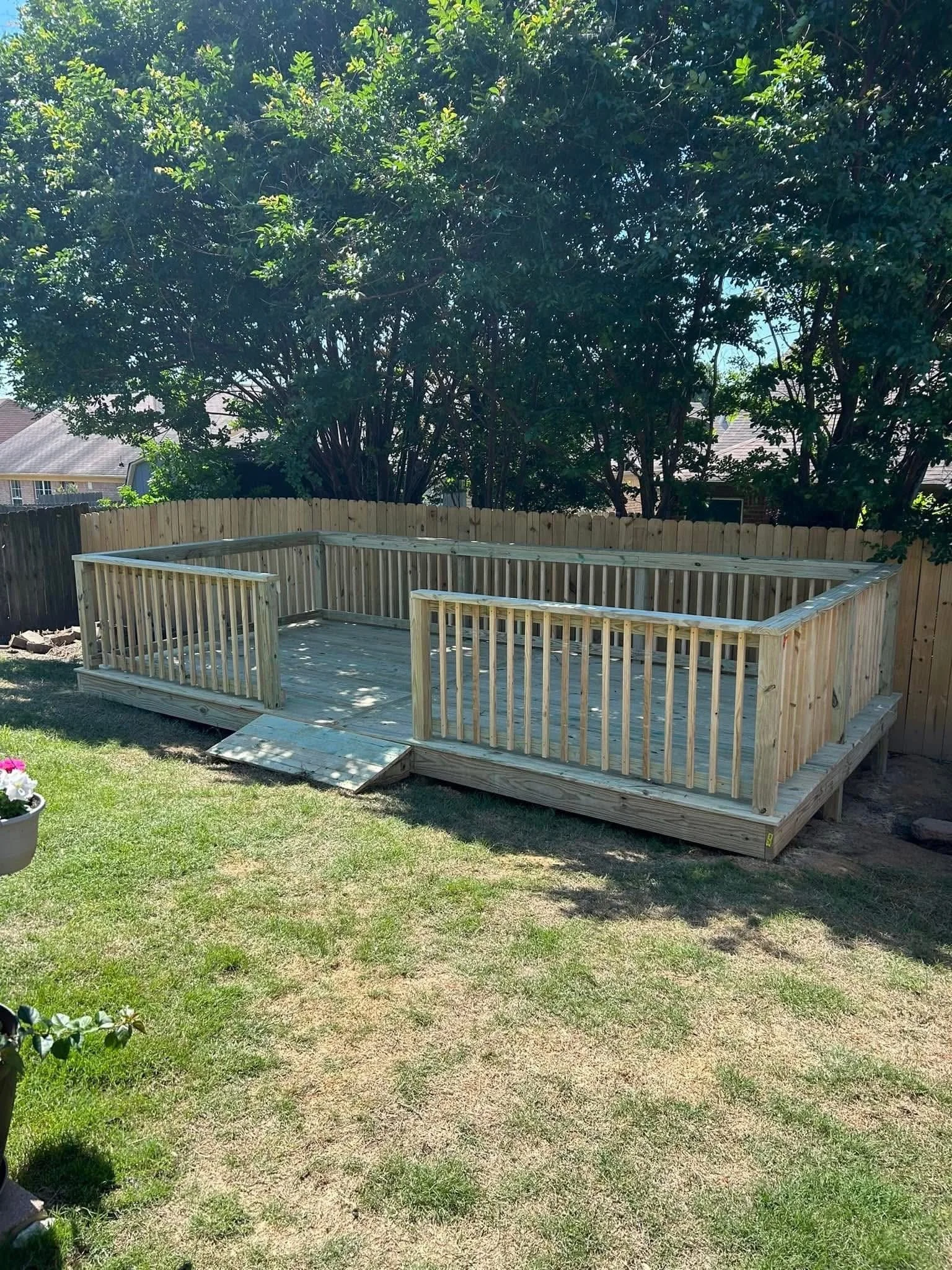 Backyard Entertainment Deck in Nesbit, Mississippi by DeSoto Fence Co. featuring pressure treated lumber, custom railings, and spacious outdoor living area designed for entertaining, relaxation, and long lasting durability.