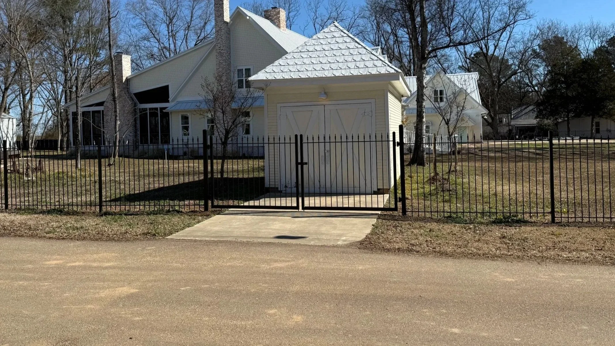 Ornamental steel fence with a matching walk gate installed at a residential property in Olive Branch, Mississippi by DeSoto Fence Co.