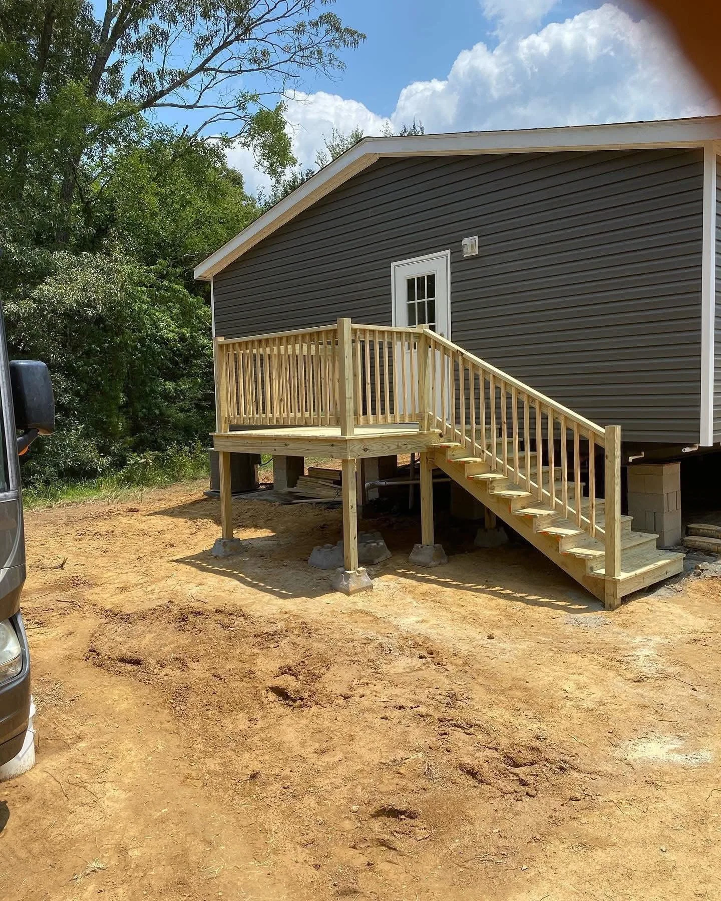 Custom Wood Deck in Olive Branch, Mississippi by DeSoto Fence Co. featuring elevated construction, custom stairs, safety railings, and pressure treated lumber built to expand outdoor living space and improve accessibility.
