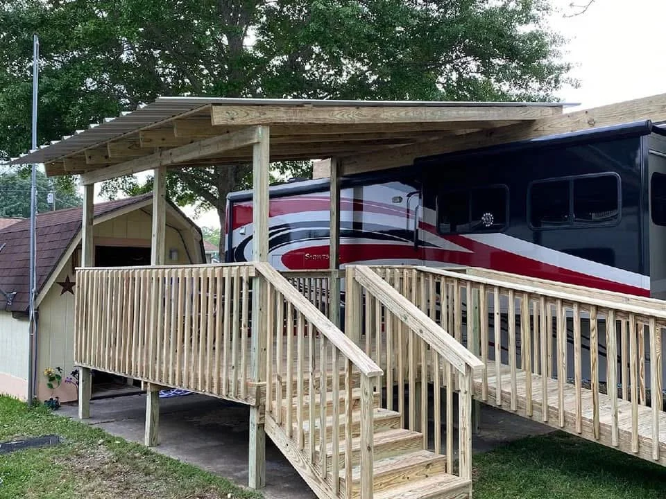 Covered RV Deck and Ramp in Olive Branch, Mississippi by DeSoto Fence Co. featuring pressure treated lumber, custom accessibility ramp, covered parking structure, and durable outdoor construction built for long lasting use and convenience.