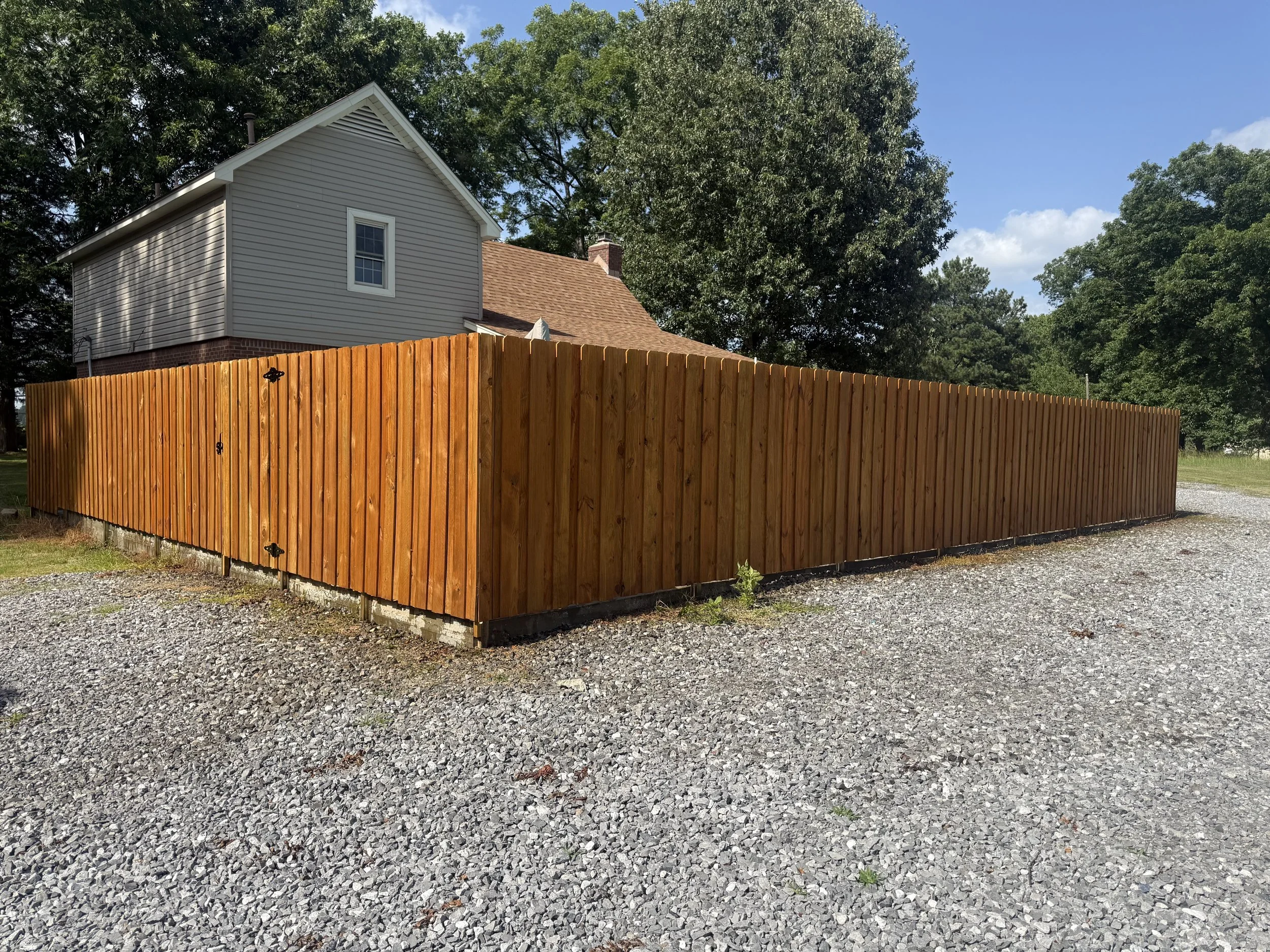 Board on board privacy fence with stain installed in Hernando, MS by DeSoto Fence Co.