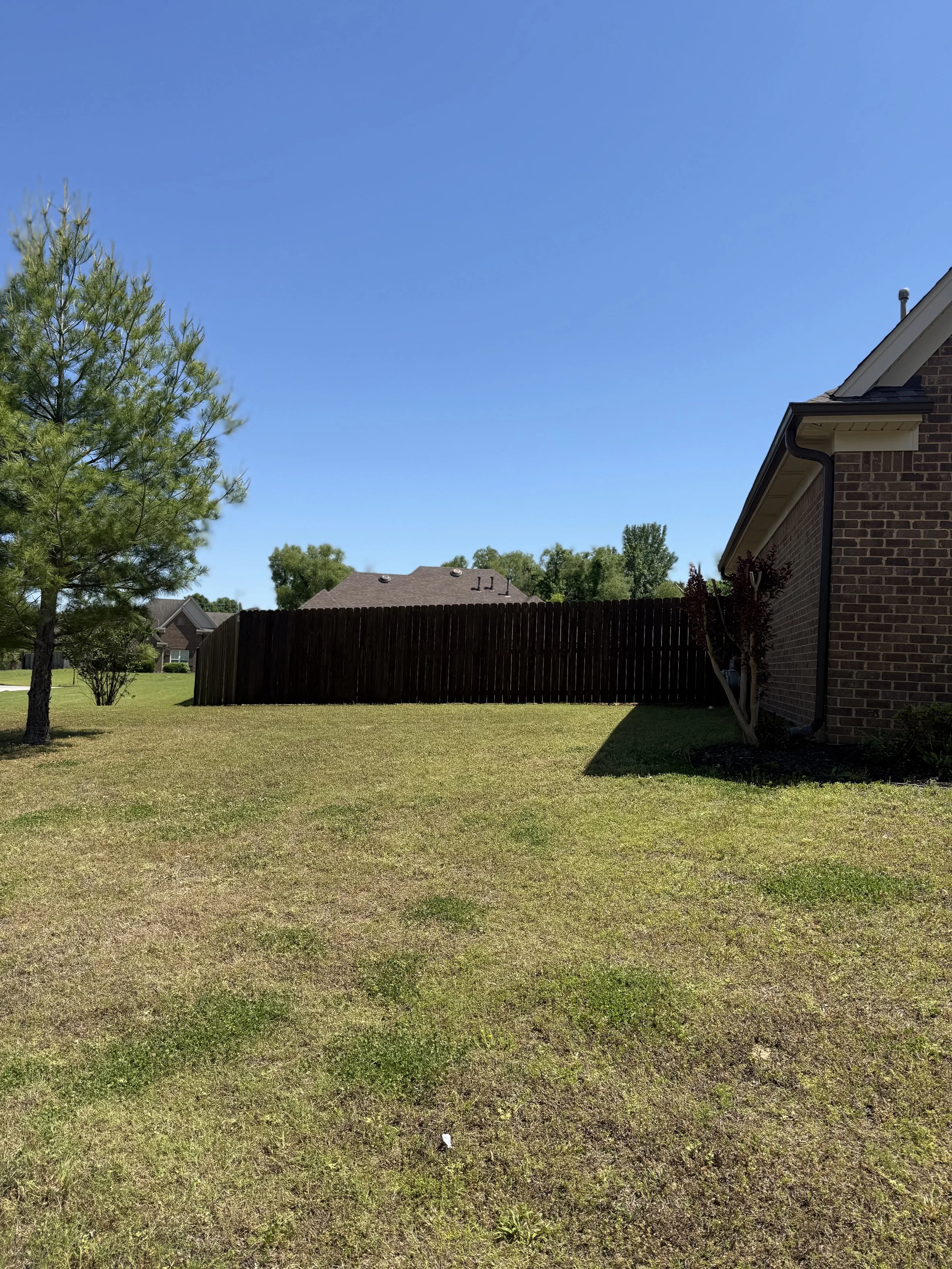 Pine privacy fence with dark walnut stain installed in Southaven, MS by DeSoto Fence Co.