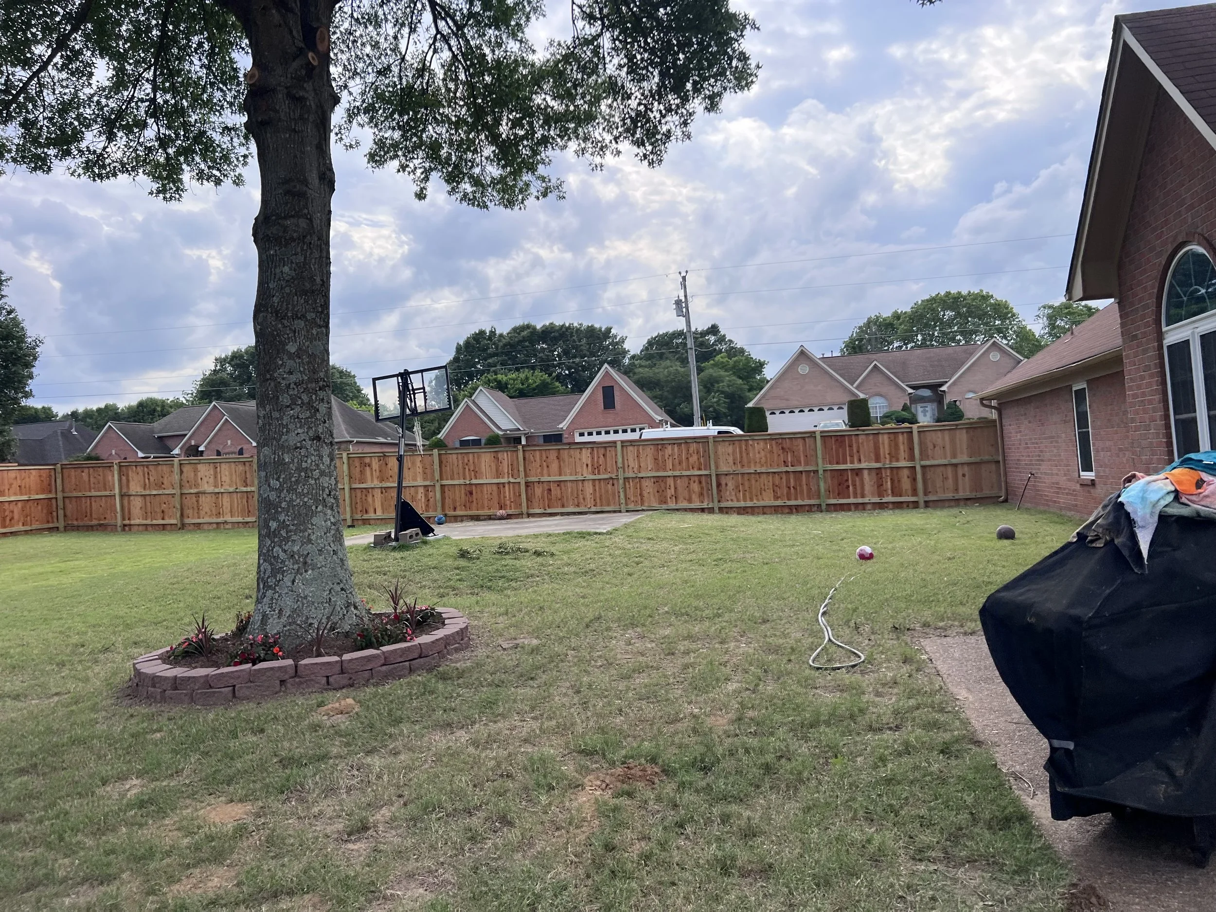 Cedar privacy fence with cedar cap, trim, and water seal completed in Olive Branch, MS by DeSoto Fence Co.