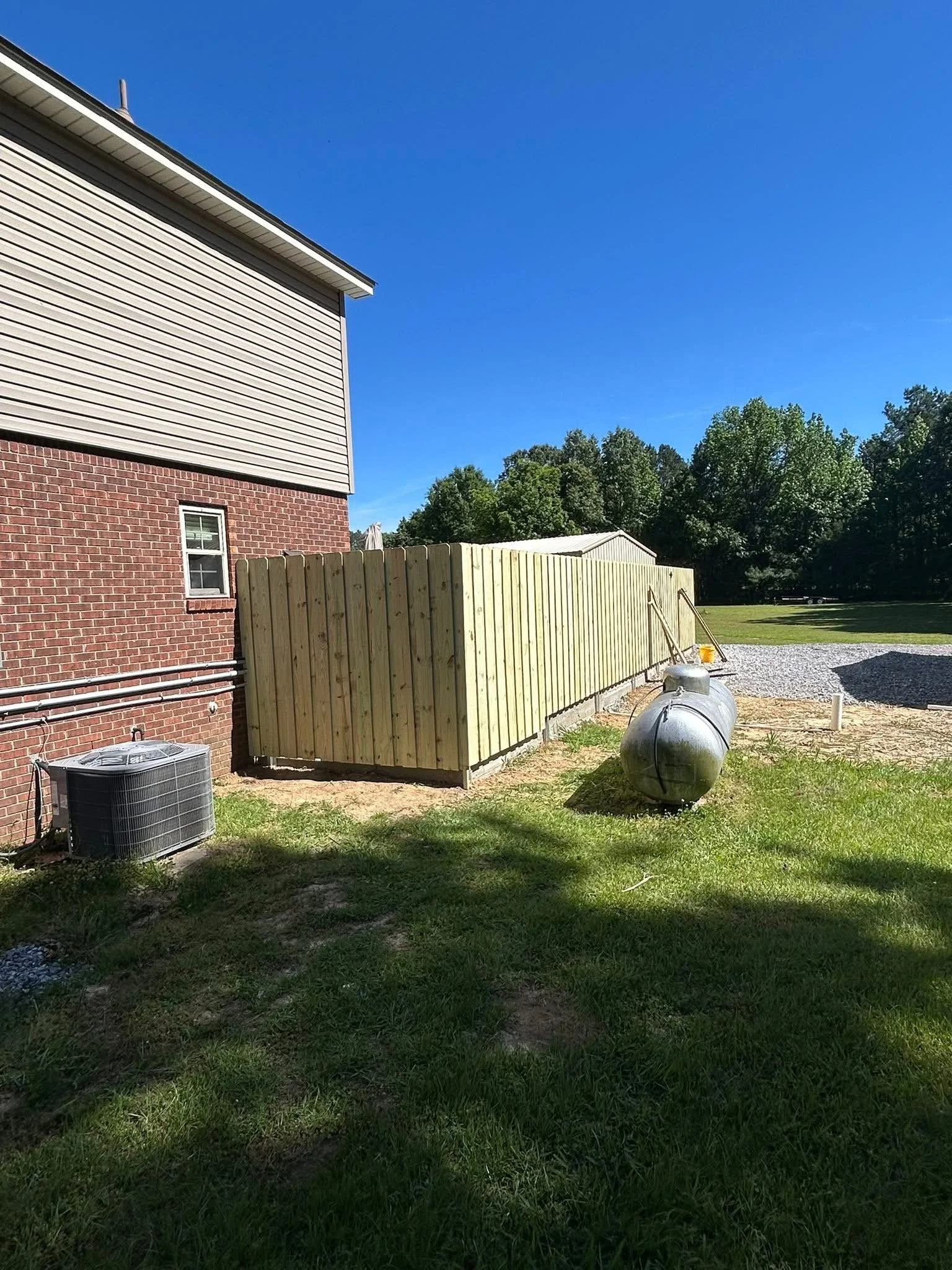 Custom board on board pressure treated pine fence built in Hernando, MS by DeSoto Fence Co.