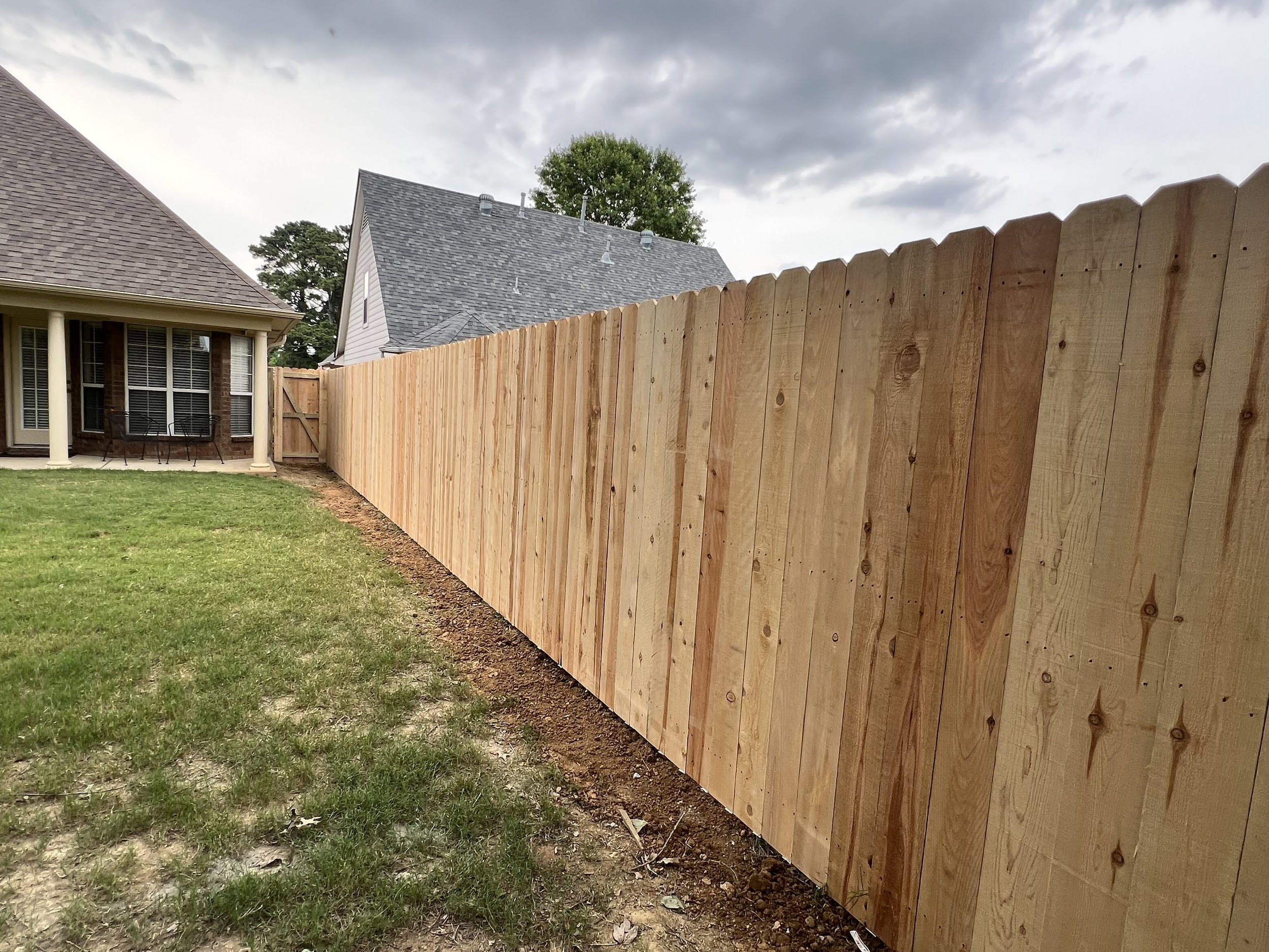 Cedar privacy fence installed in Hernando, MS featuring full-height pickets and a clean, straight layout across the backyard. Built for privacy with consistent spacing and solid structure throughout the entire run.