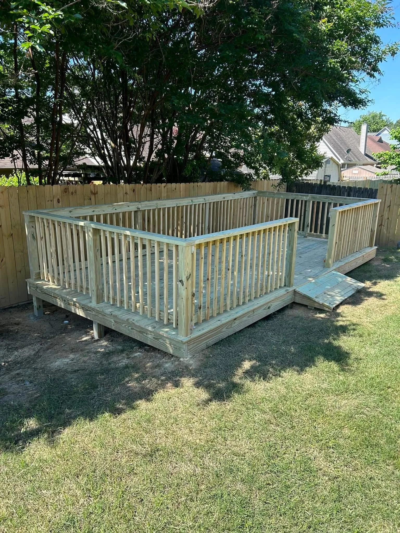 Backyard Entertainment Deck in Nesbit, Mississippi by DeSoto Fence Co. featuring pressure treated lumber, custom railings, and spacious outdoor living area designed for entertaining, relaxation, and long lasting durability.