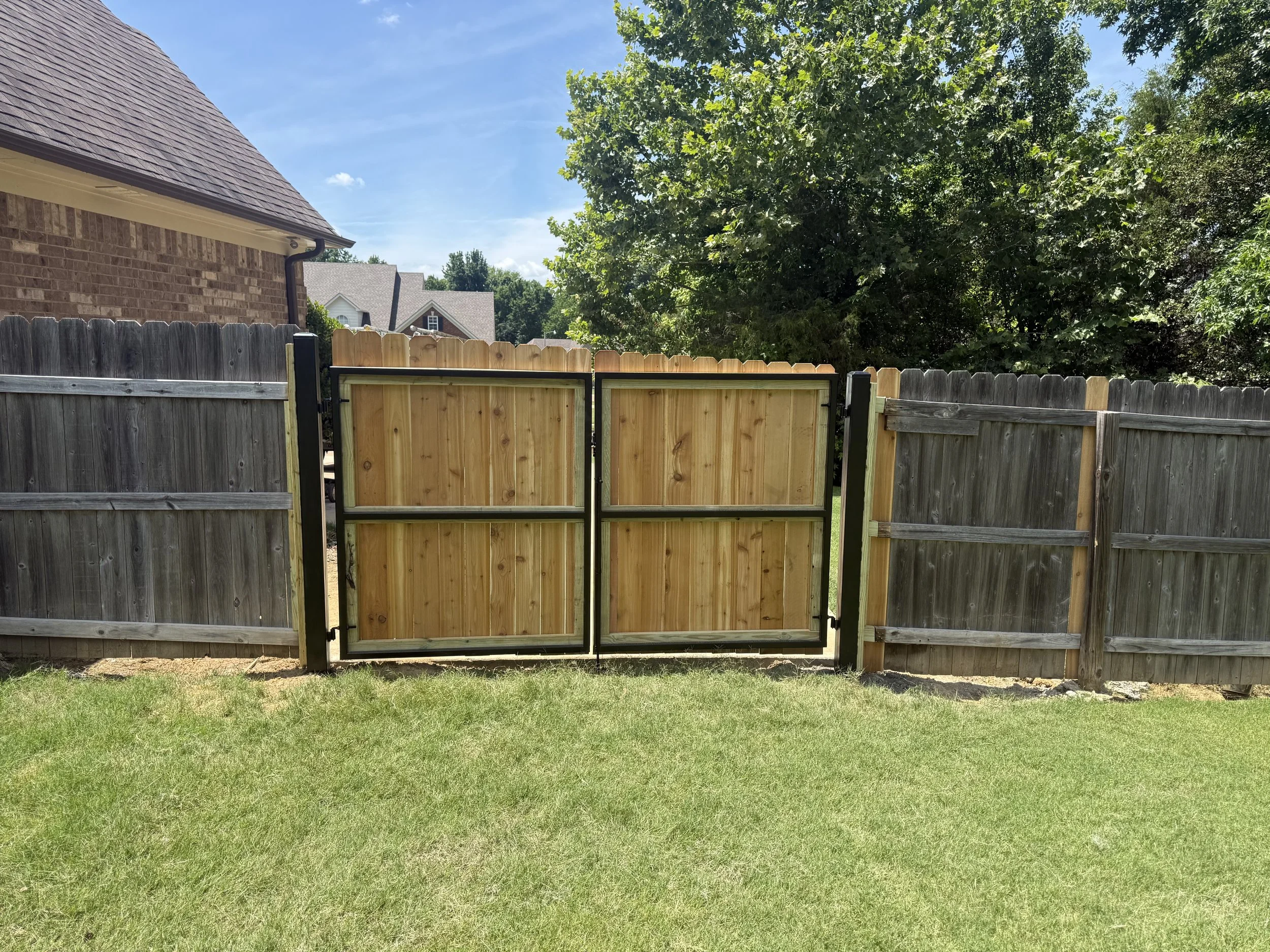 Custom metal frame gate with cedar privacy pickets installed in Hernando, MS for superior durability, security, and long-lasting performance by DeSoto Fence Co.