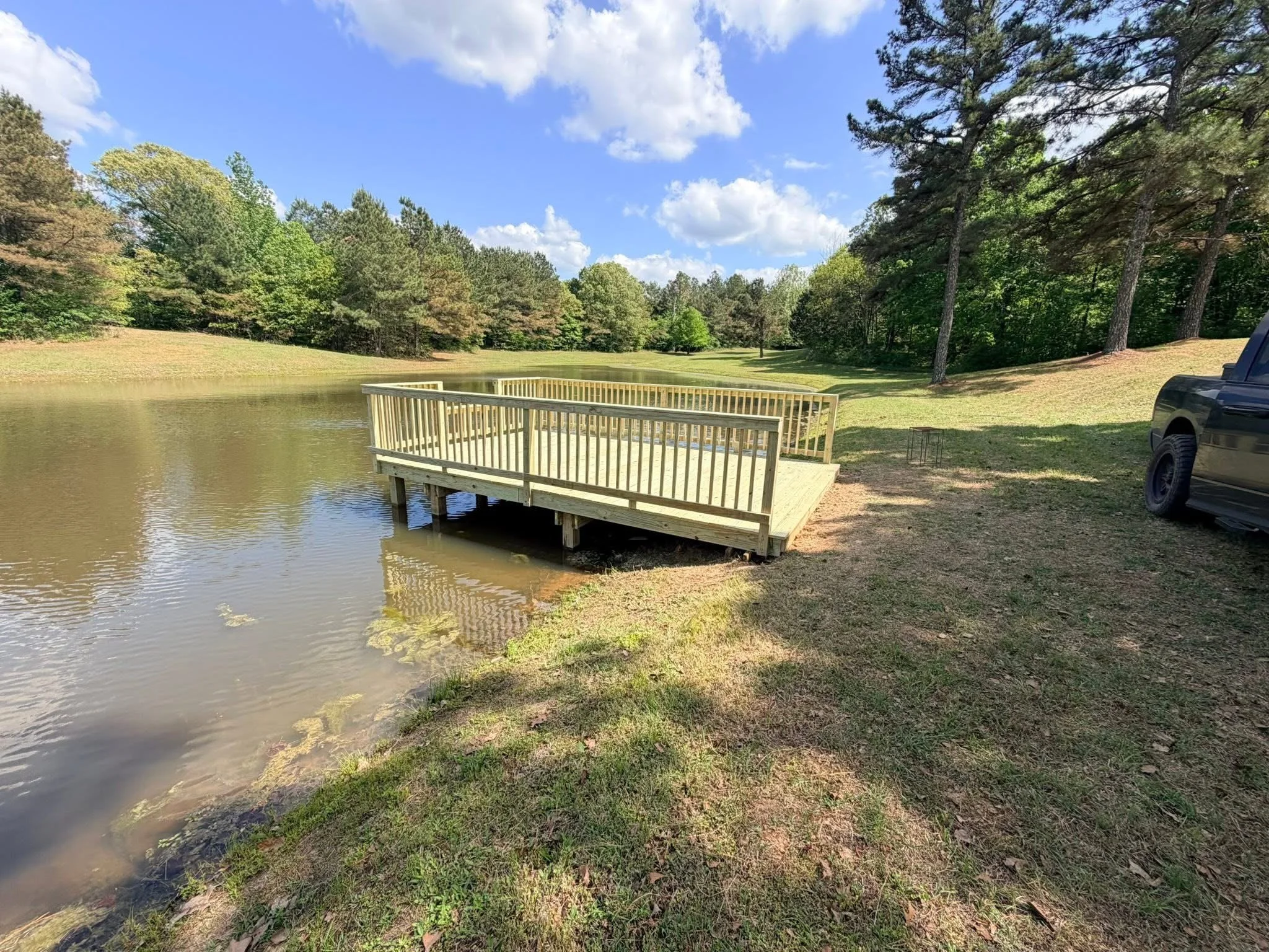 Custom Floating Dock in Hernando, Mississippi by DeSoto Fence Co. featuring pressure treated lumber, spacious waterfront platform, safety railings, and durable dock construction designed for fishing, boating, and lakeside enjoyment.