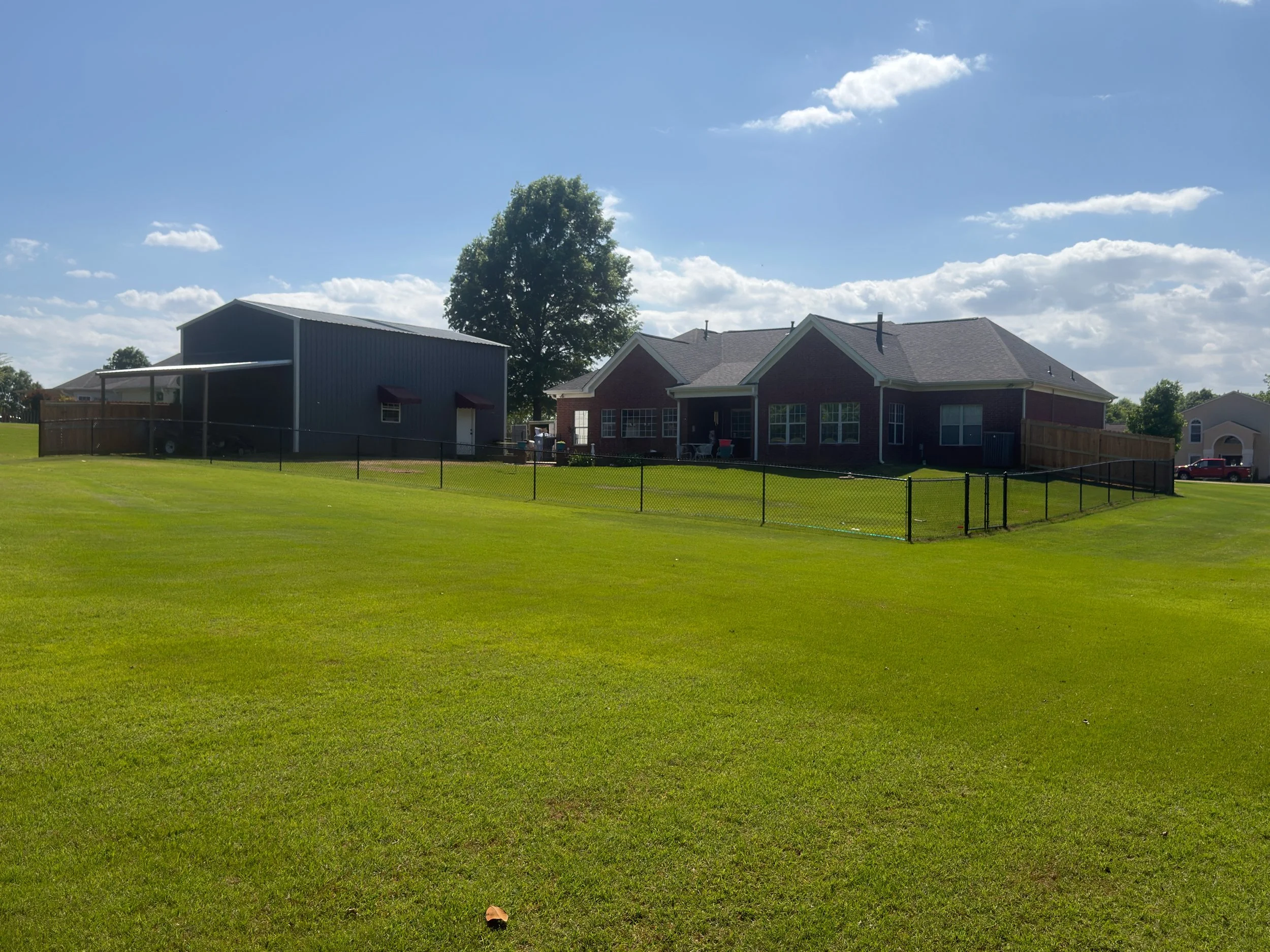 Residential black chain link fence built in Hernando, MS by DeSoto Fence Co.