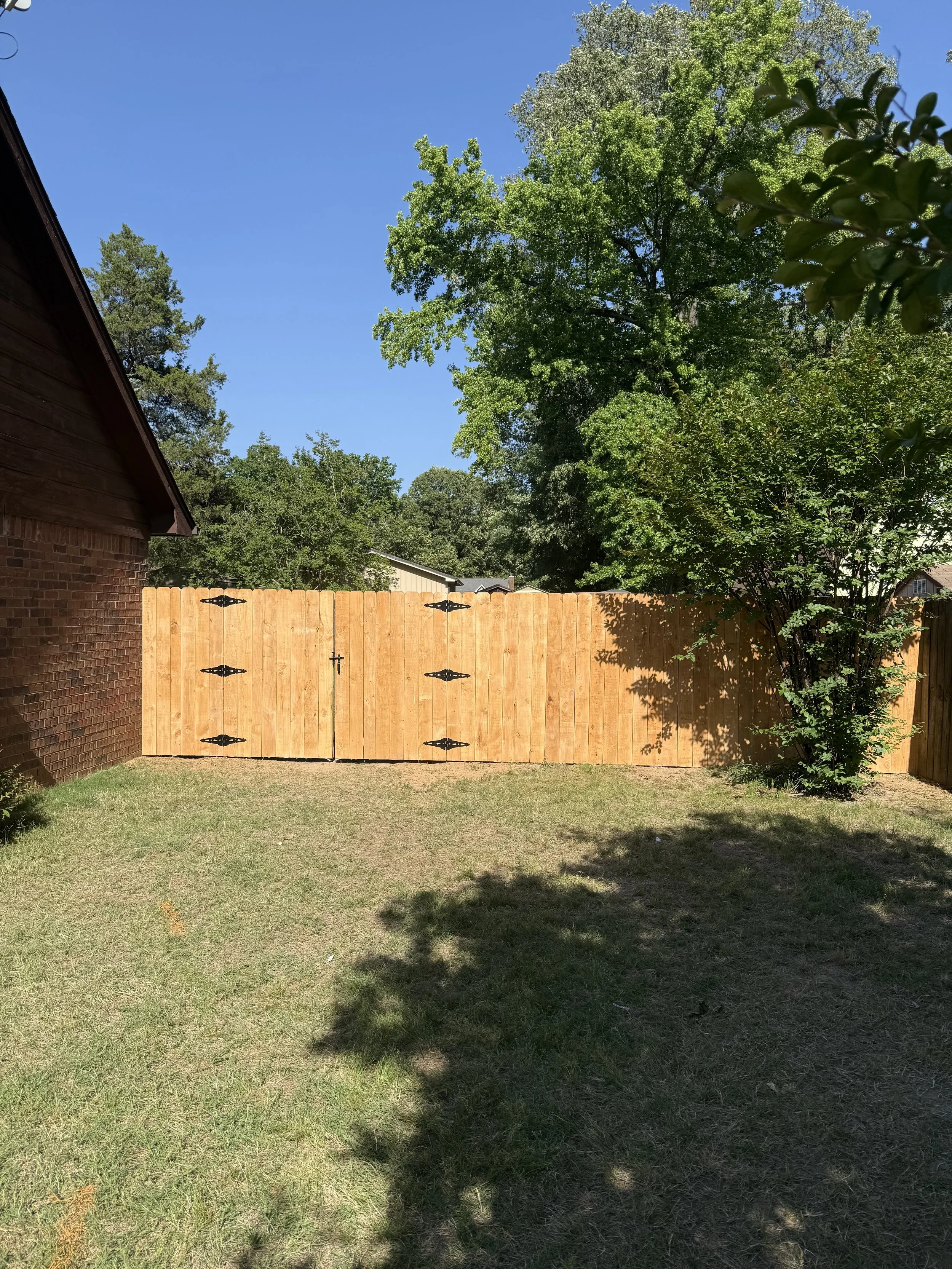 Premium pressure treated pine fence with custom double gates built in Nesbit, MS by DeSoto Fence Co.