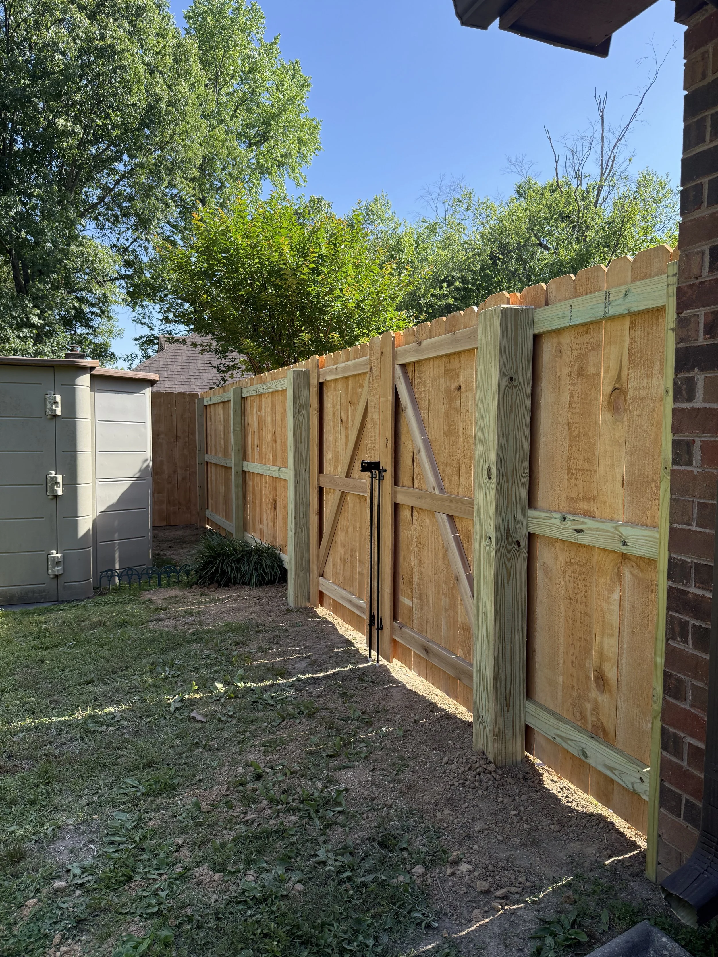 Premium pine privacy fence with custom double gates installed in Nesbit, MS by DeSoto Fence Co.