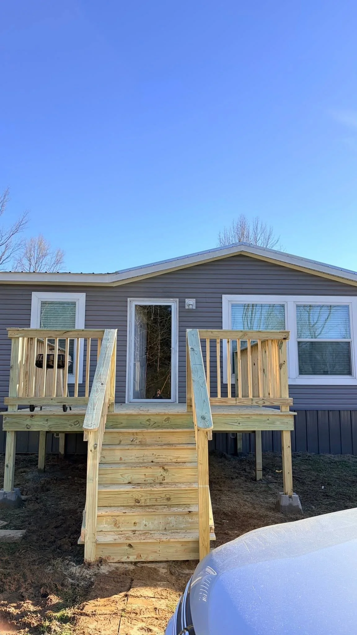 Elevated Wood Deck in Hernando, Mississippi by DeSoto Fence Co. featuring pressure treated lumber, custom stairs, safety railings, and elevated construction designed to expand outdoor living space and provide long lasting durability.