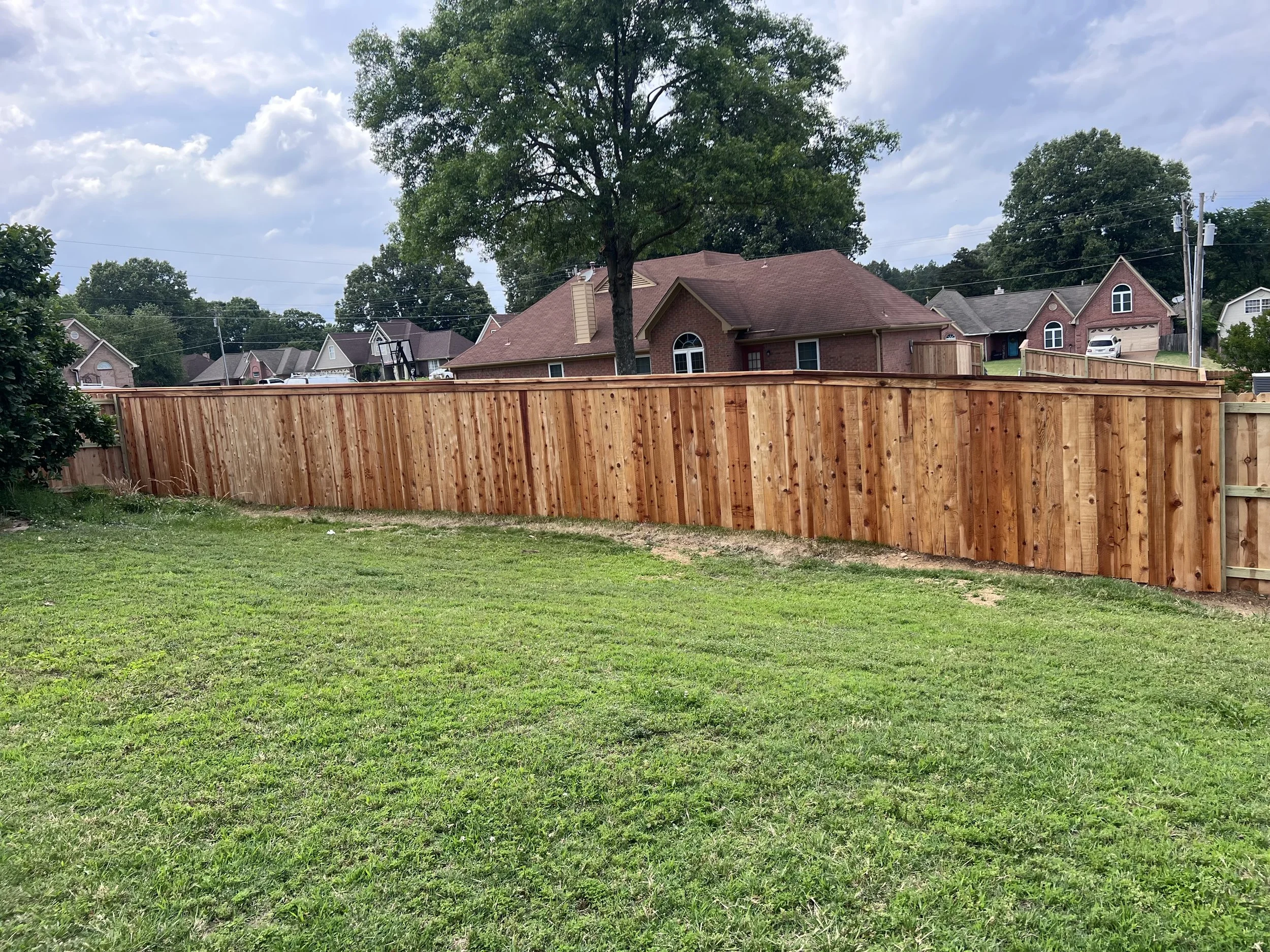 Custom cedar privacy fence with cedar cap and trim installed in Olive Branch, MS by DeSoto Fence Co.