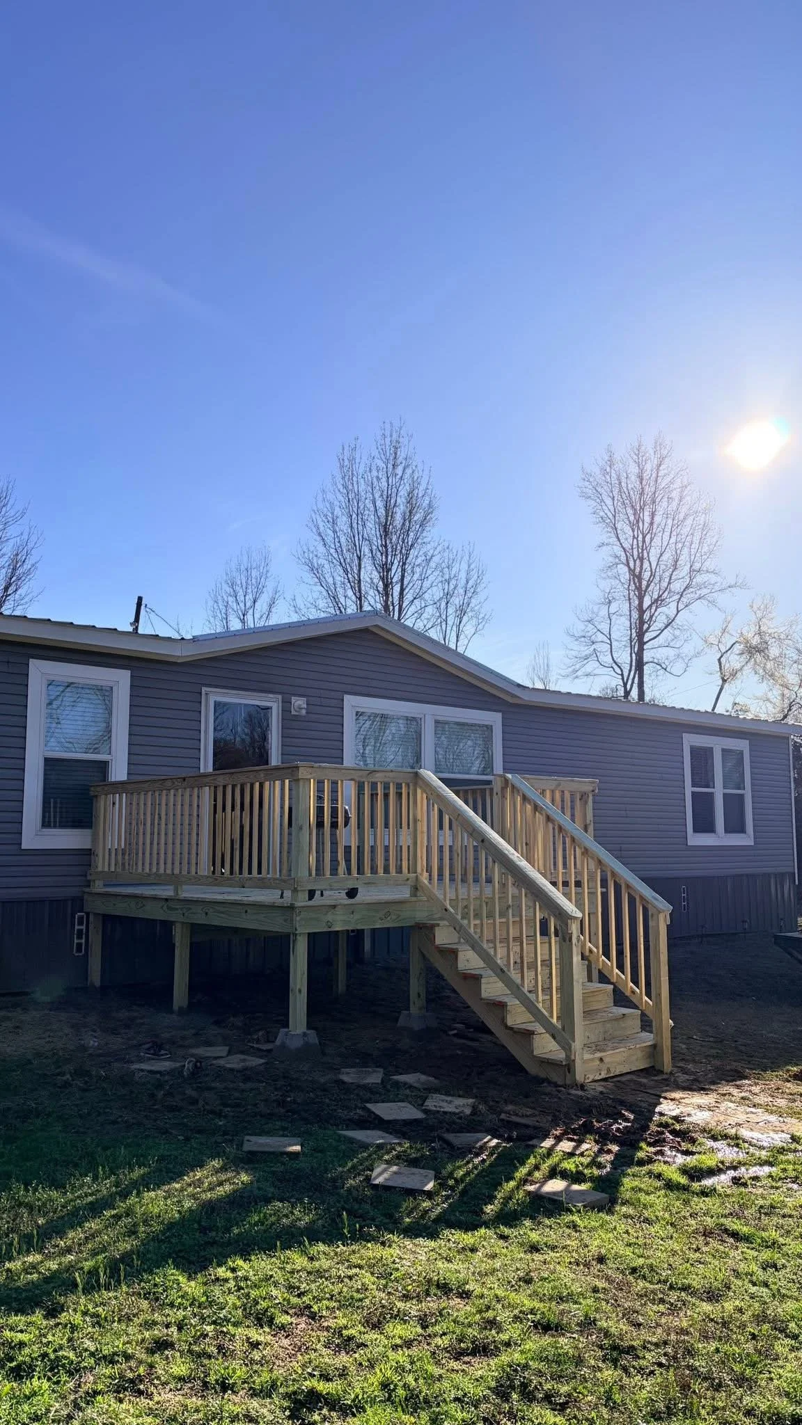 Elevated Wood Deck in Hernando, Mississippi by DeSoto Fence Co. featuring pressure treated lumber, custom stairs, safety railings, and elevated construction designed to expand outdoor living space and provide long lasting durability.