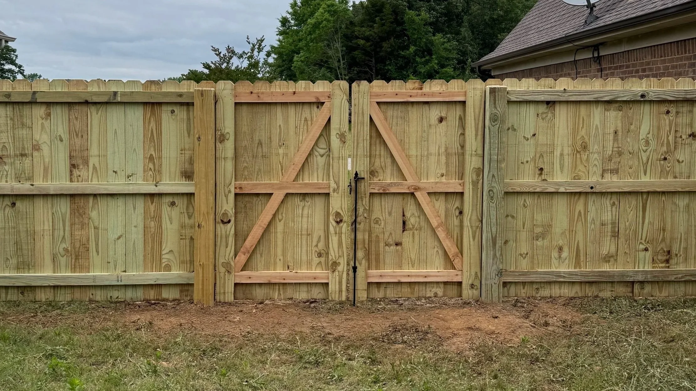 Double pine privacy fence gate with cedar 2x4 framing installed as part of a residential privacy fence in Southaven, Mississippi by DeSoto Fence Co.